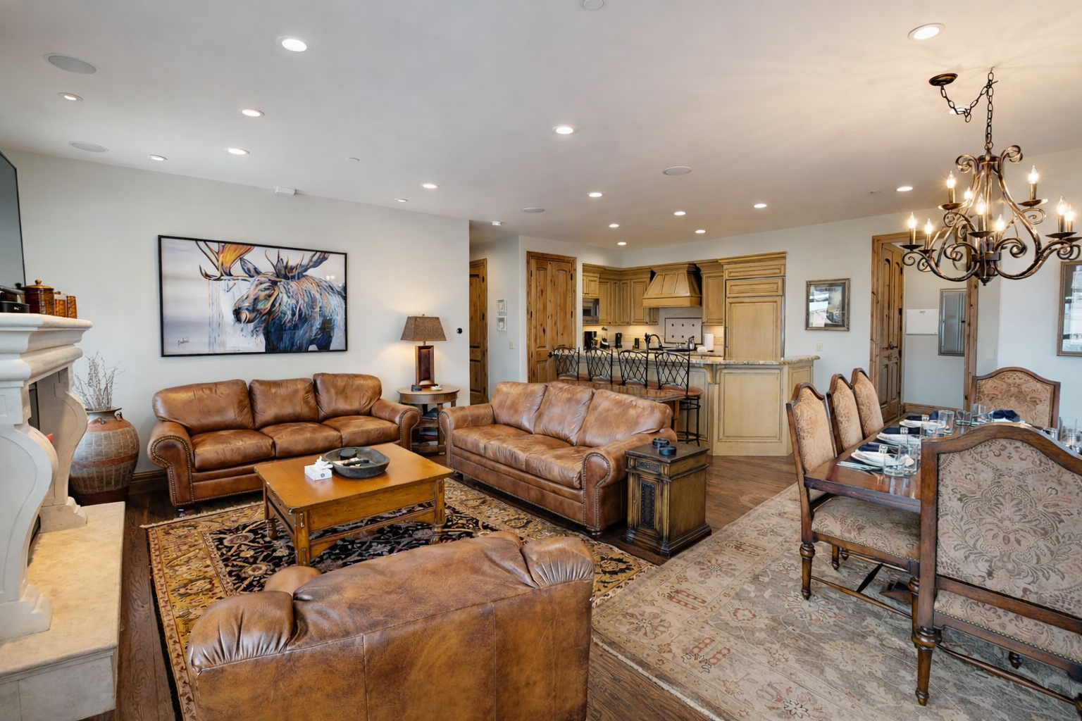 Experience the ultimate mountain getaway at Strand Haus, a luxurious ski-in/ski-out condo. This spacious retreat features high ceilings, an open living area, and a large dining space with stunning alpine views.