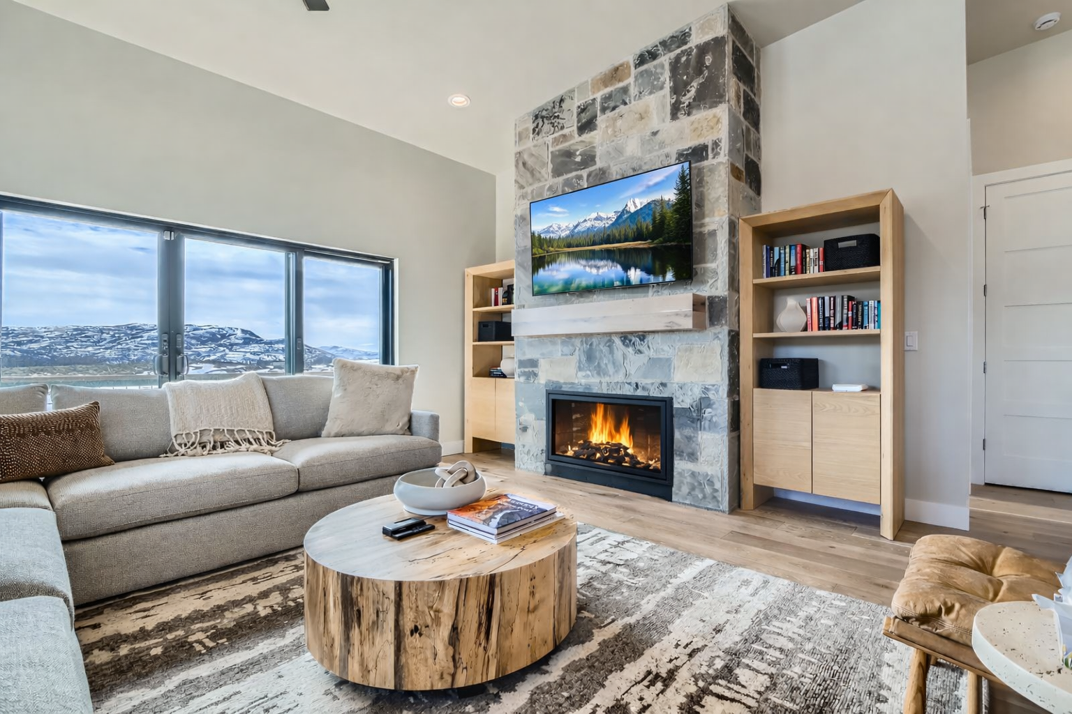Unwind in your stylish living room where a crackling fireplace and mountain views create the perfect après-ski retreat.
