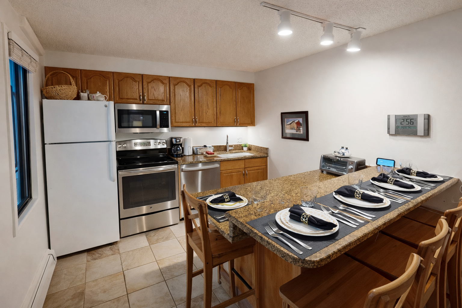 Your fully equipped kitchen awaits with granite counters, stainless appliances, and elegant table setting for memorable meals together.
