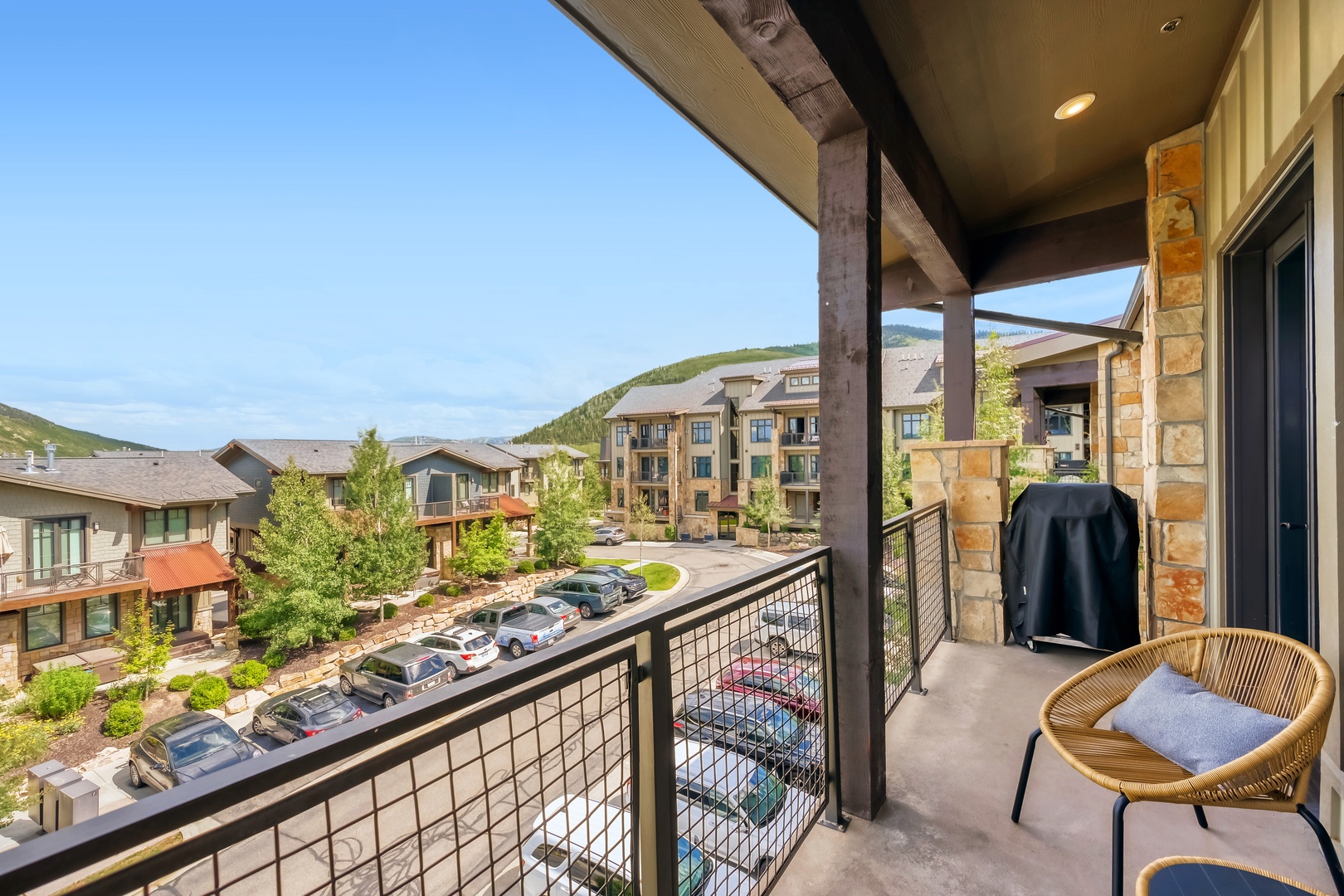 A well-appointed mountain escape with a private balcony overlooking the surrounding resort community and rolling hills beyond.