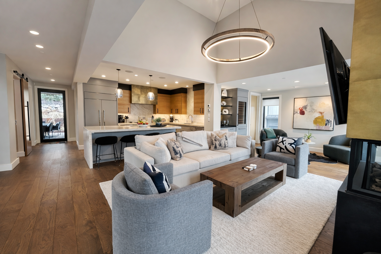 Unwind in this sophisticated living room where modern elegance meets mountain charm, complete with a cozy fireplace and stunning views.