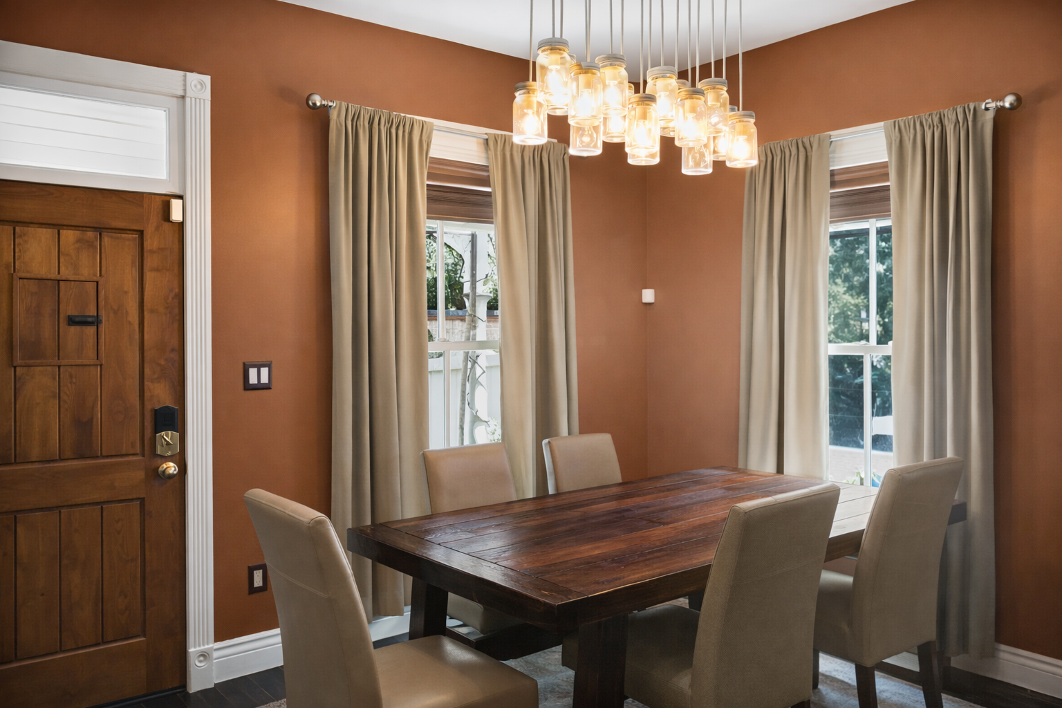 Gather around this stunning dining table where warm amber pendant lights create the perfect atmosphere for memorable meals together.