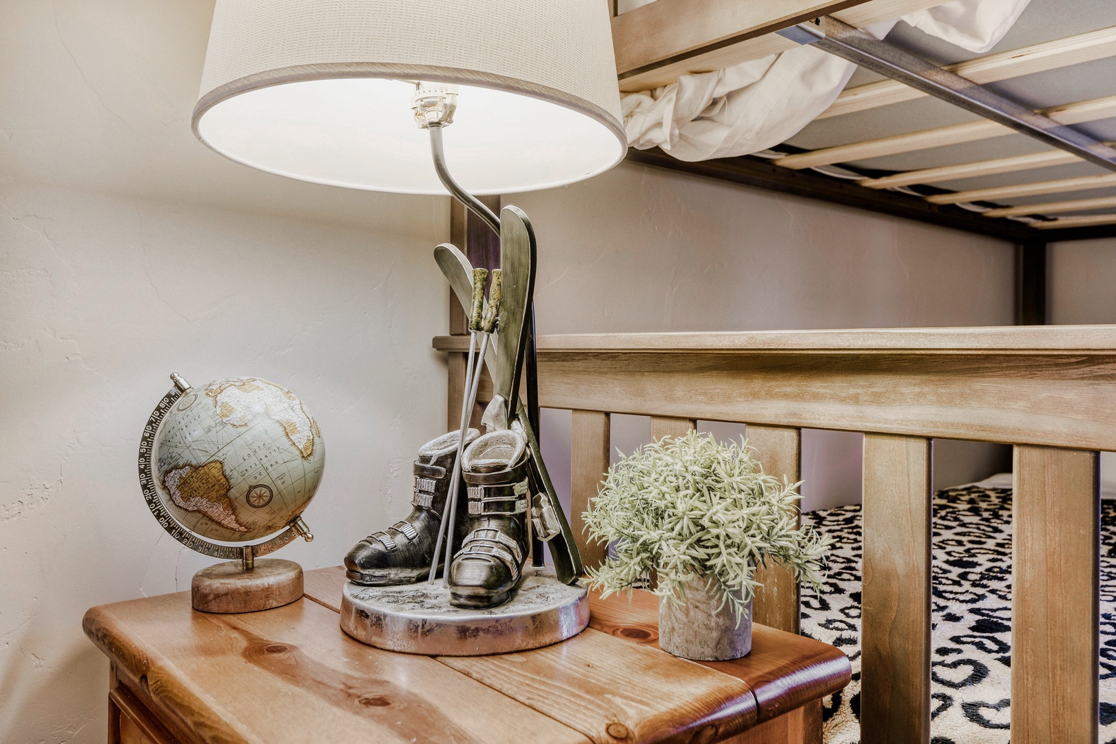 A thoughtfully styled bedside space invites your mountain adventures, with vintage ski décor and warm wood touches creating a cozy retreat after a day on the slopes.