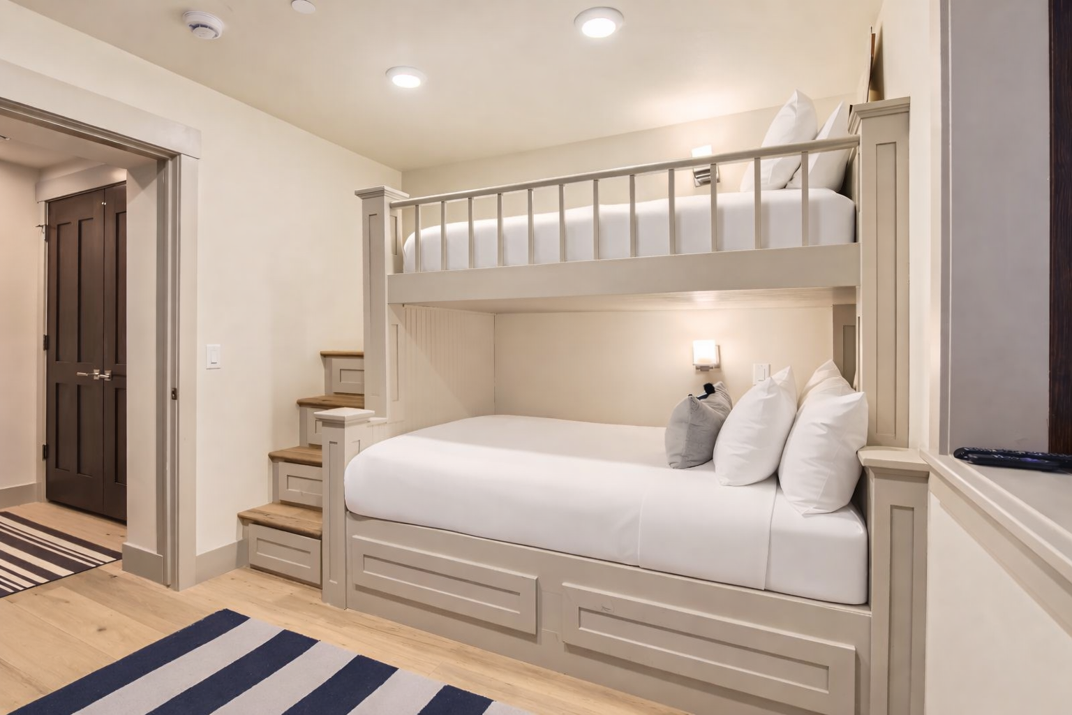 Sleep soundly in the dedicated bunk room, featuring two cozy beds with easy stair access and built-in storage. Ideal for families or groups.
