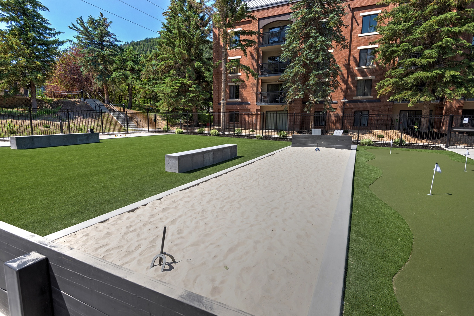 Your getaway includes access to a private outdoor recreation area with a putting green and sand trap, framed by towering evergreens and peaceful mountain views.