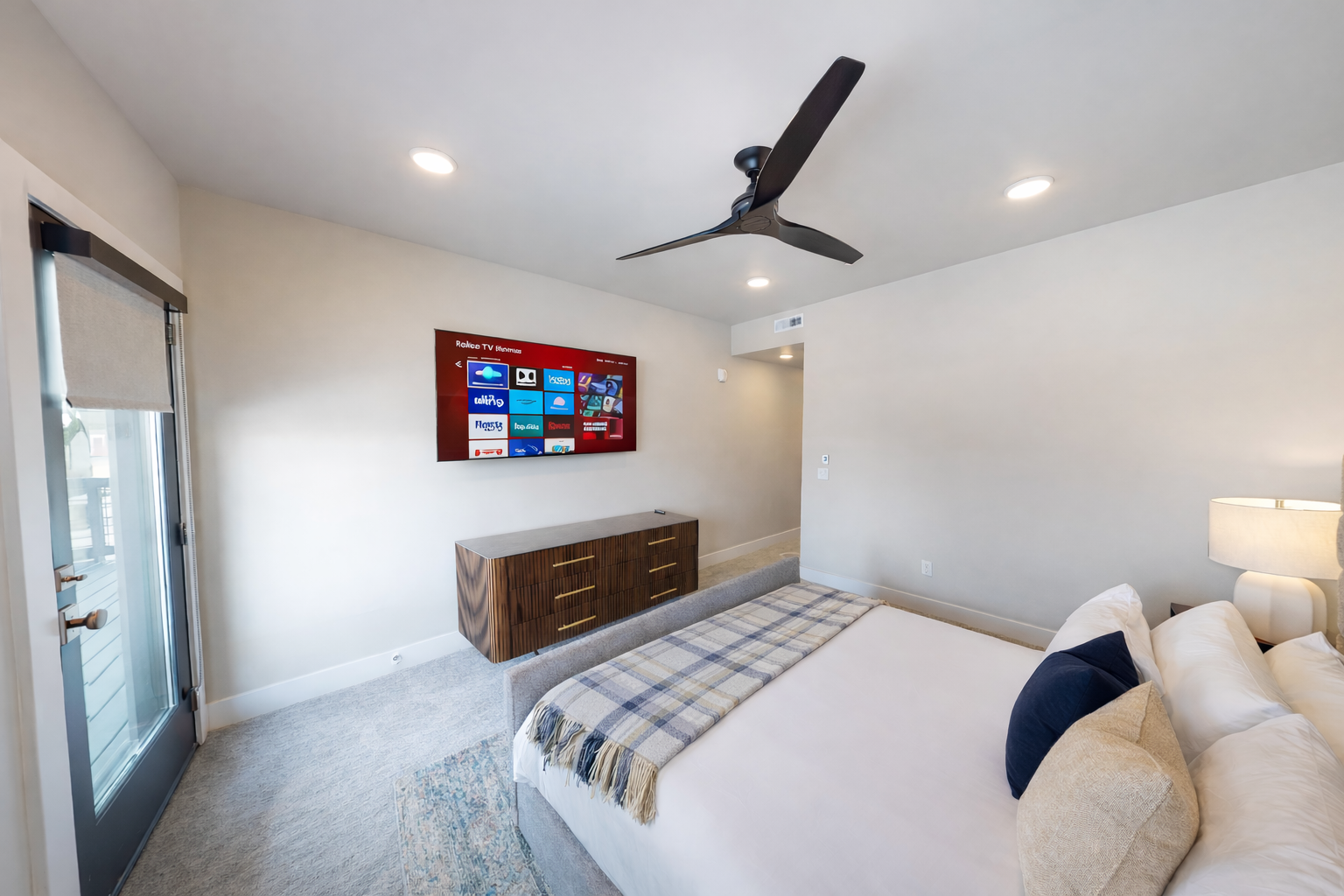 Retreat to this tranquil, modern primary suite featuring a plush king-sized bed with a stylish channeled headboard. Soft, neutral tones and a spacious layout create a serene sanctuary for your ultimate relaxation.