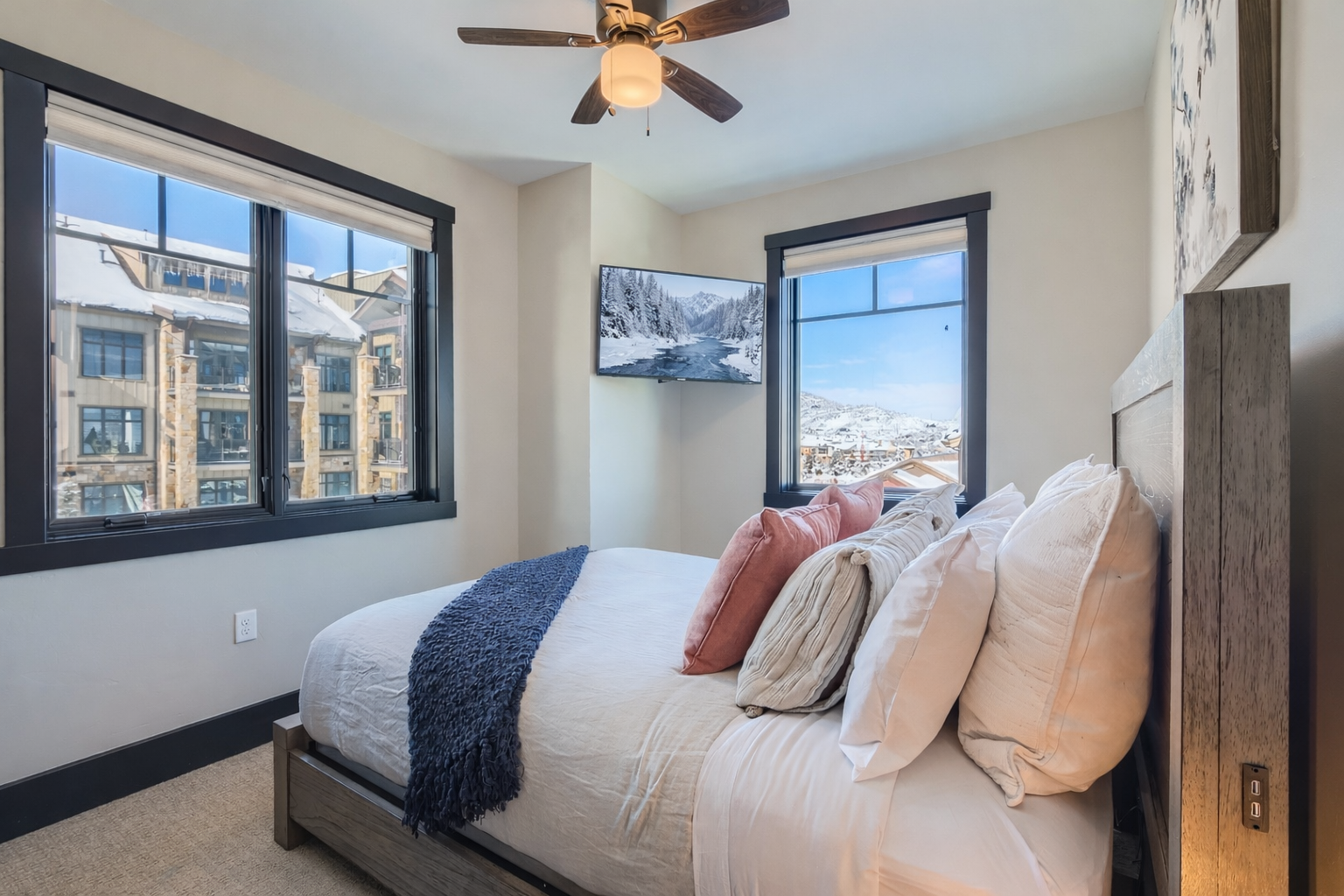 Experience modern rustic elegance in this well-lit suite. Features include a comfortable queen bed, soft textiles, and scenic views, providing a peaceful and inviting stay for every guest.