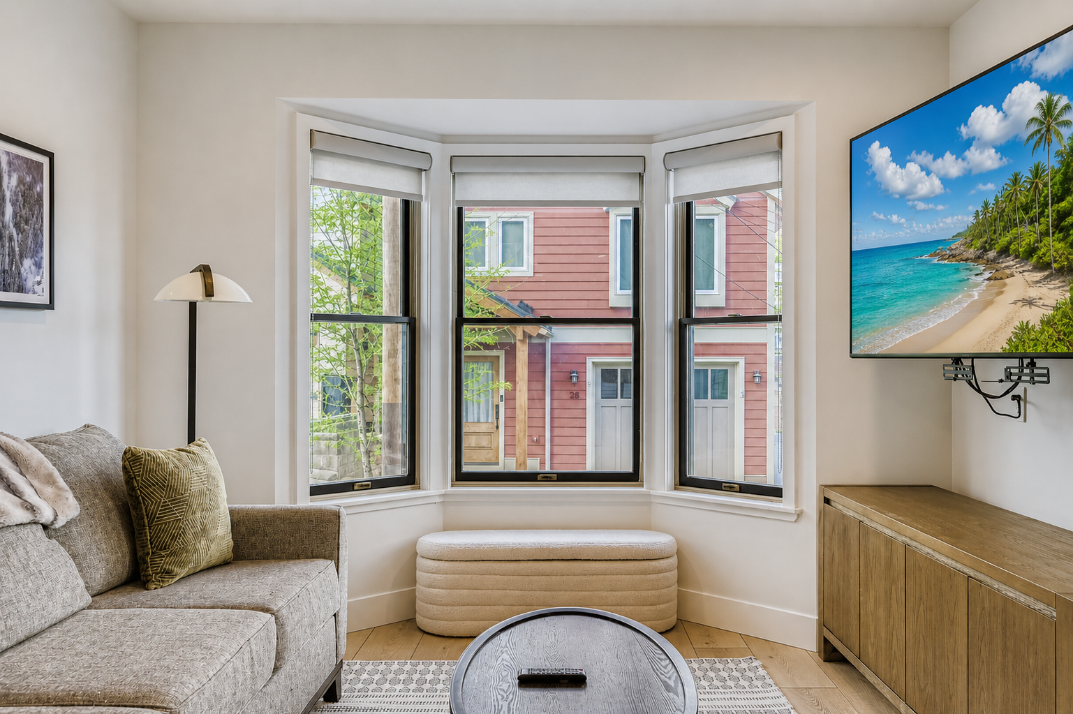 Sink into this bright living room where your morning coffee tastes better by the charming bay window. Natural light floods the space as you watch neighborhood life unfold outside.
