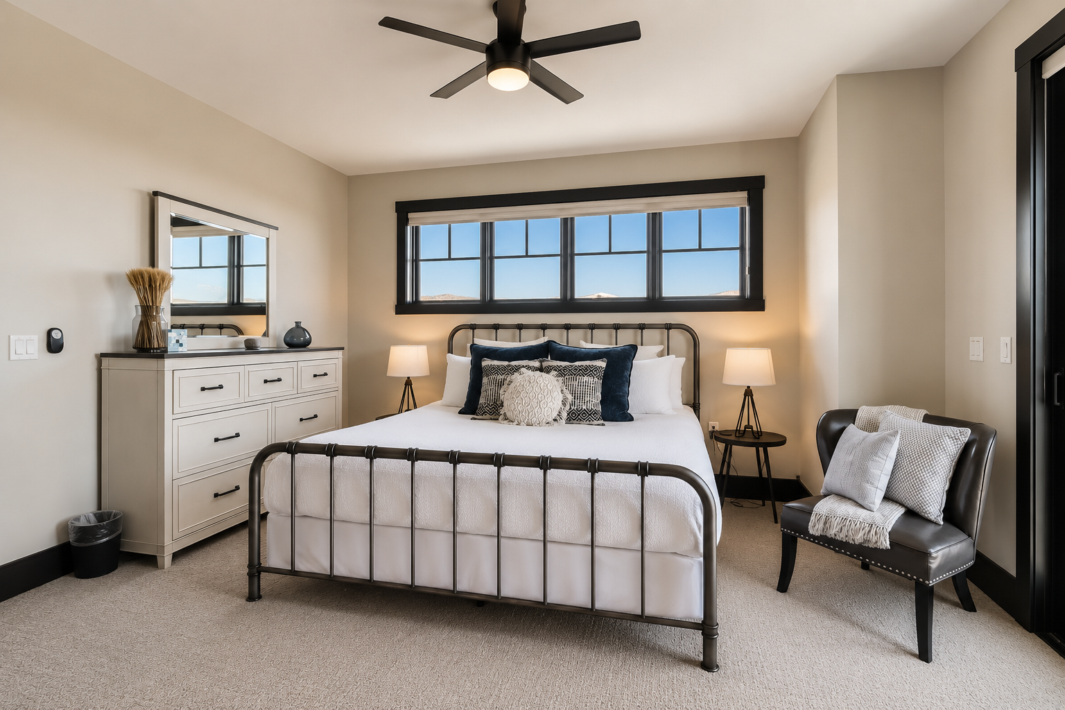 Relax in this bright master suite featuring a plush king bed and a cozy fireplace. Large windows and a private balcony offer serene views for a perfect mountain retreat.