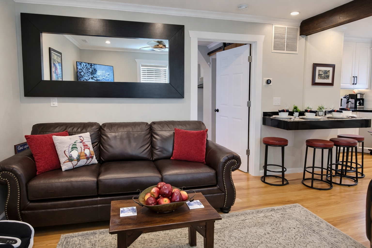 Unwind in the cozy living room with a stunning stone fireplace, large leather sectional sofa, and smart TV.