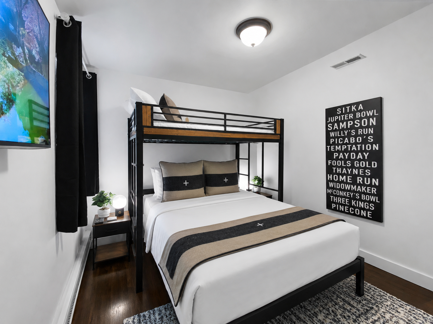 Your stylish bedroom features a cozy queen bed with a bunk above, perfect for families or groups. Crisp linens, modern decor, and warm wood tones create a welcoming retreat.