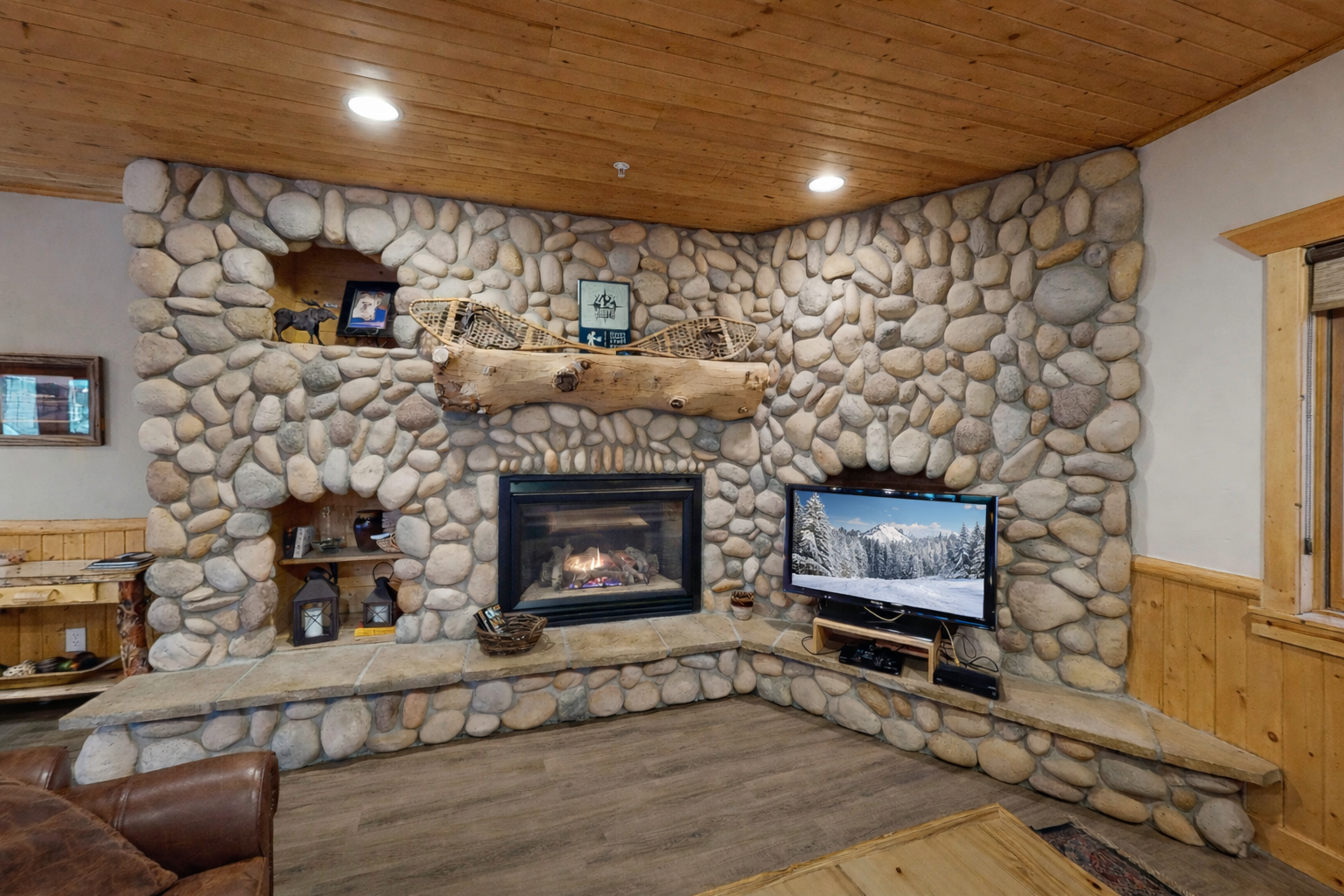 Gather around this stunning stone fireplace where you'll find your perfect cozy evening spot, complete with crackling flames and entertainment for memorable nights together.