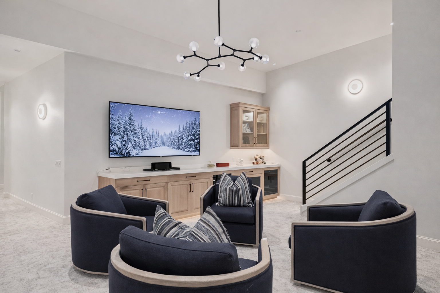 Sink into plush curved seating while you enjoy movie nights on the large TV in this sophisticated living space.