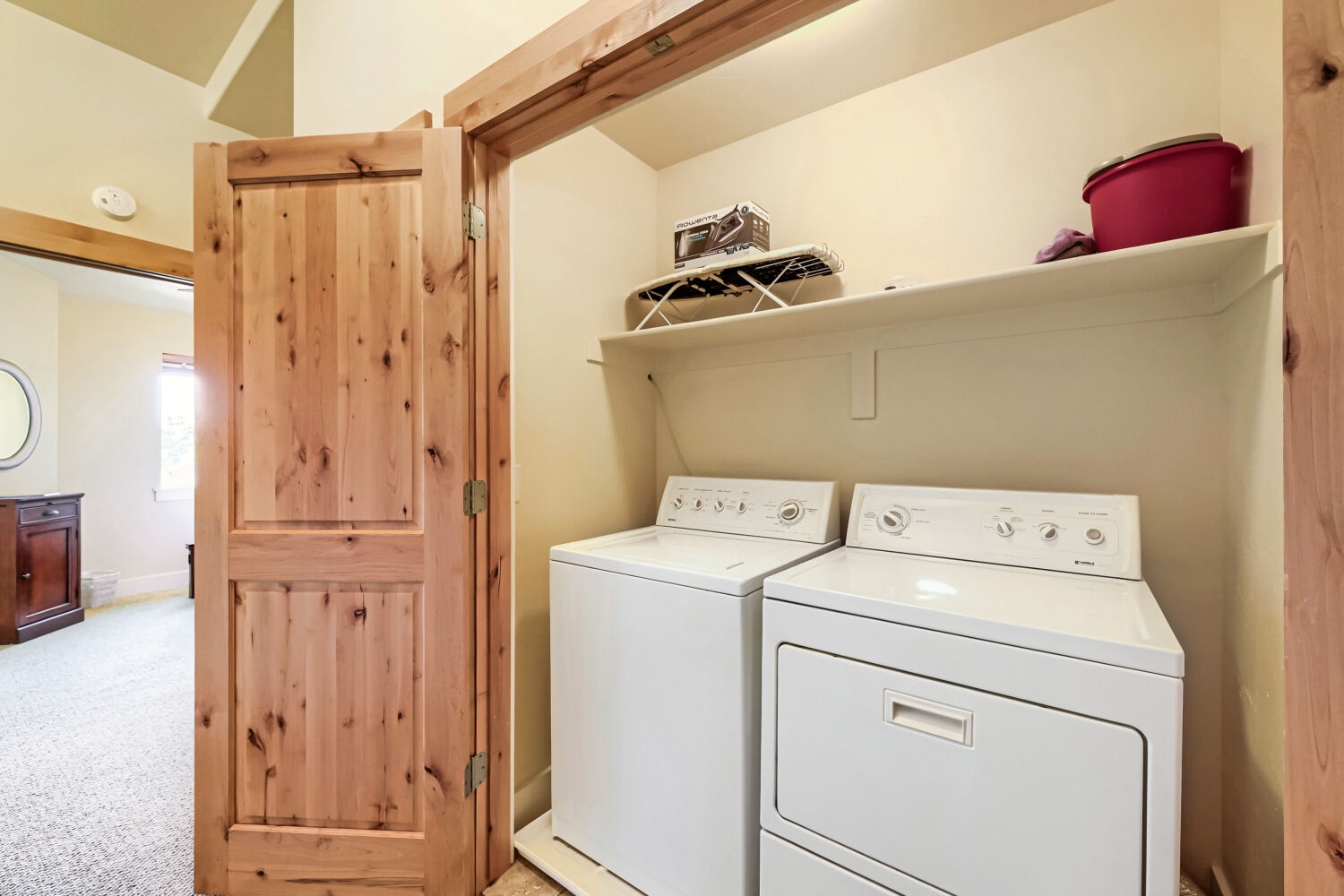 Your dedicated laundry nook ensures you can pack light and enjoy fresh clothes throughout your stay, tucked conveniently behind a charming rustic door.