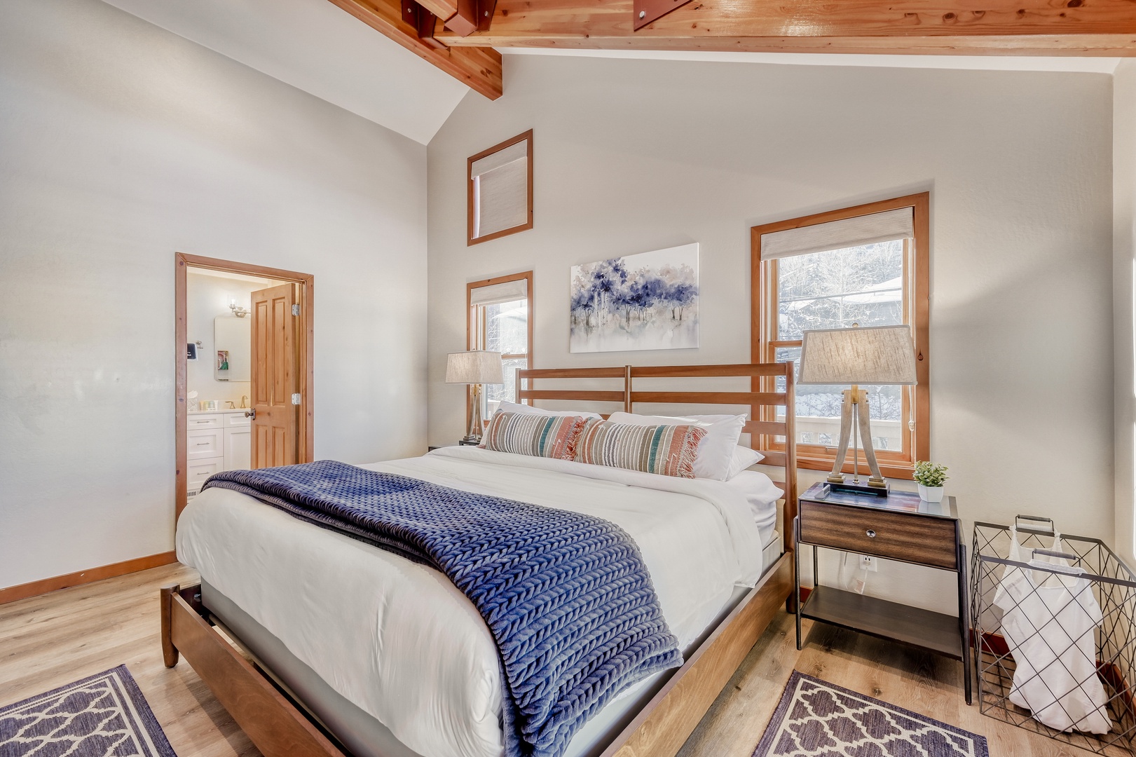 Rest peacefully in your cozy bedroom with exposed wood beams, soft linens, and warm natural light streaming through your windows.