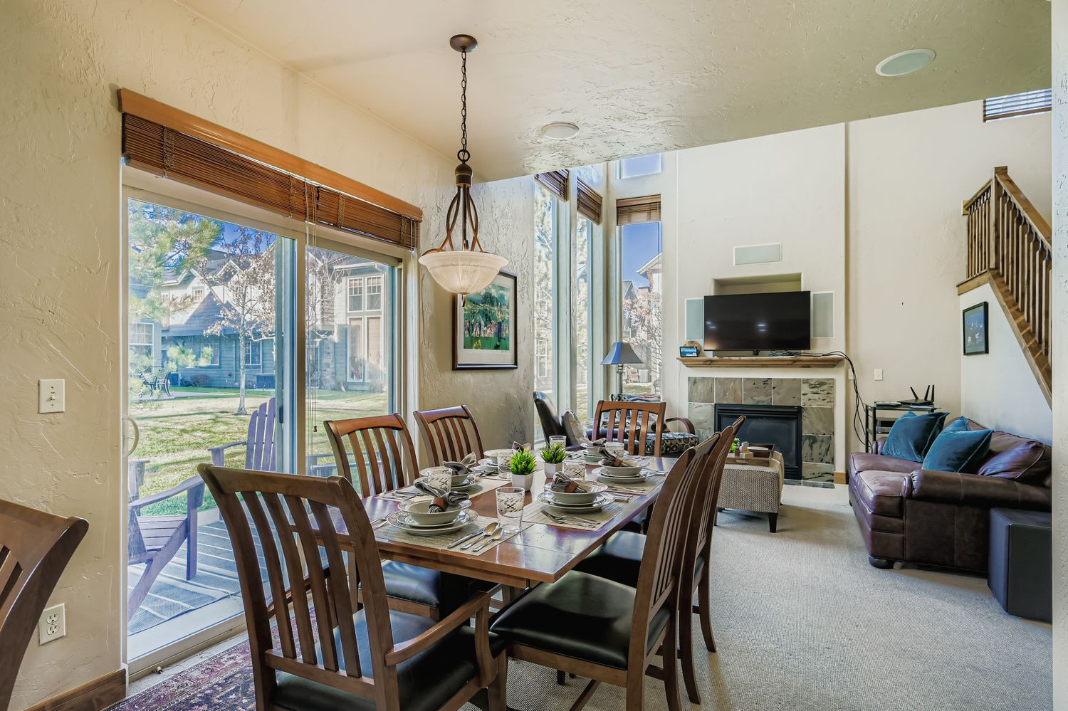 Your open-concept dining and living area features elegant furnishings, a cozy fireplace, and large windows that flood the space with natural light for memorable meals and relaxation.