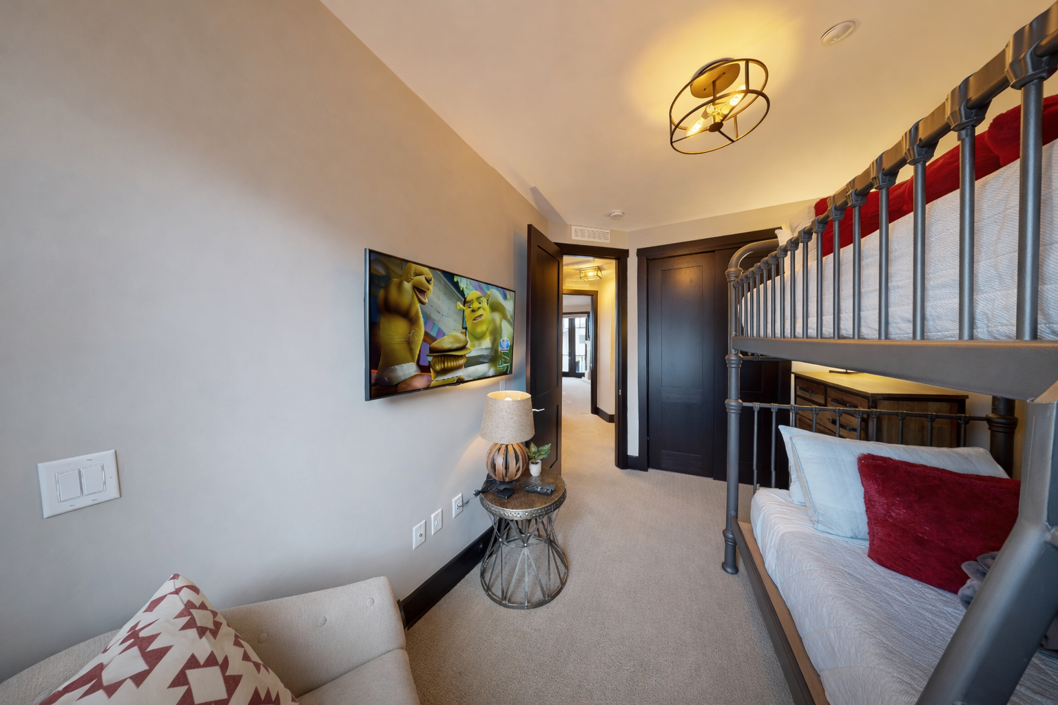 Your cozy retreat features custom bunk beds with plush linens and a wall-mounted TV for family movie nights.