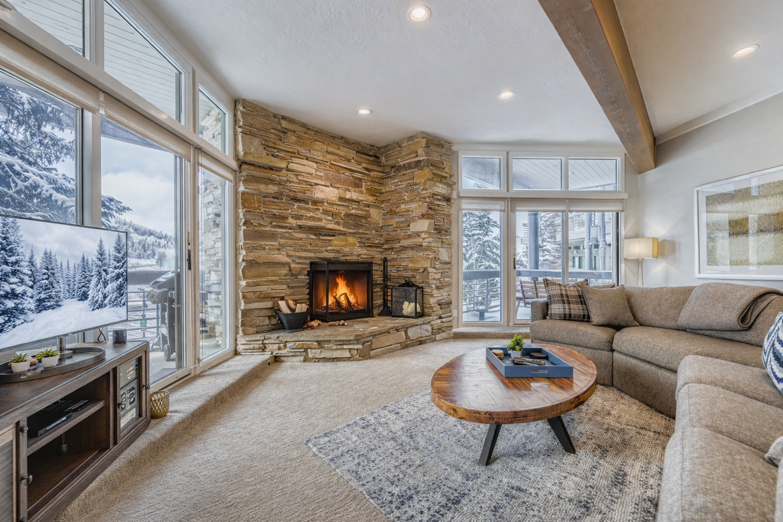 Curl up on the plush sectional sofa by your crackling stone fireplace, watching snow fall through floor-to-ceiling windows.