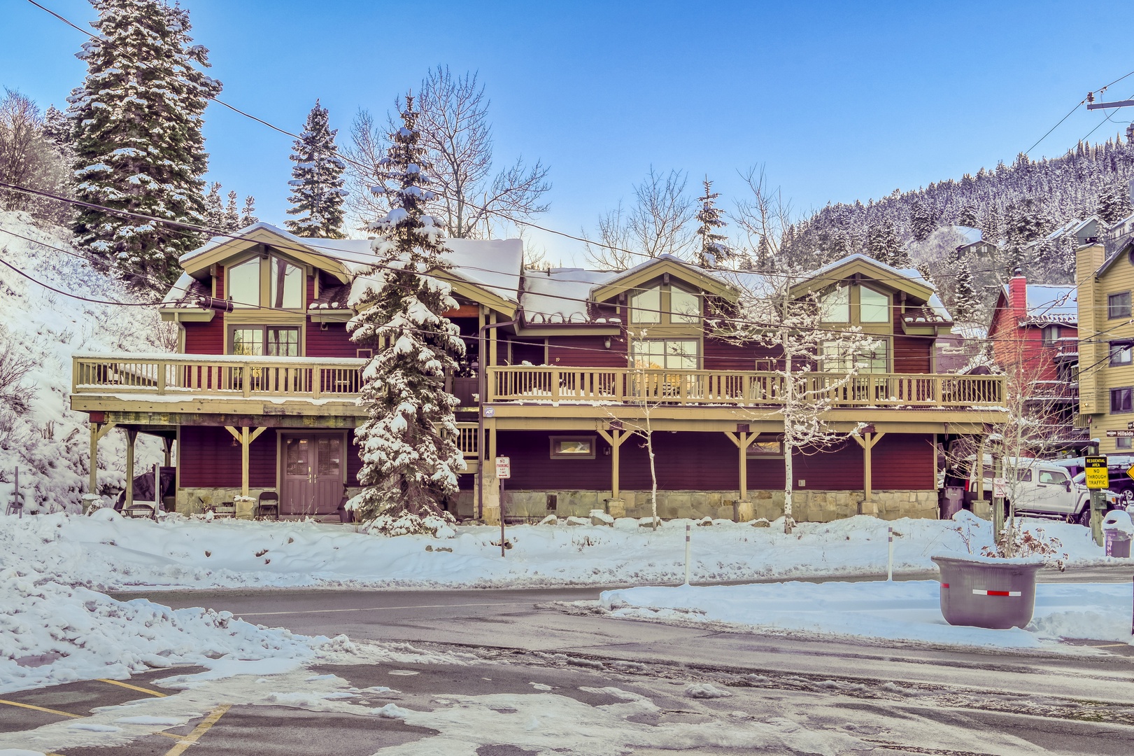 Mountain lodge nestled in snowy forest with ski-in access and alpine charm.