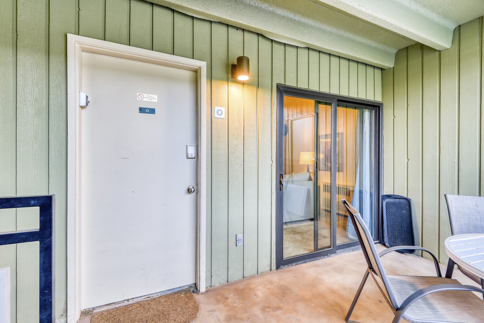 Step onto your private balcony where comfortable chairs await and sliding doors reveal your cozy bedroom retreat.