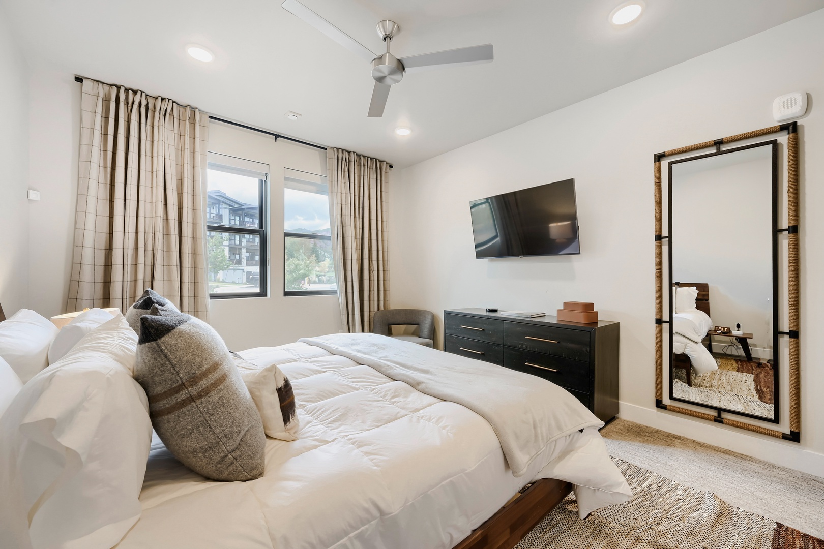 Sink into plush linens in this serene bedroom, where soft natural light and a calming neutral palette create your perfect retreat after a day of adventure.