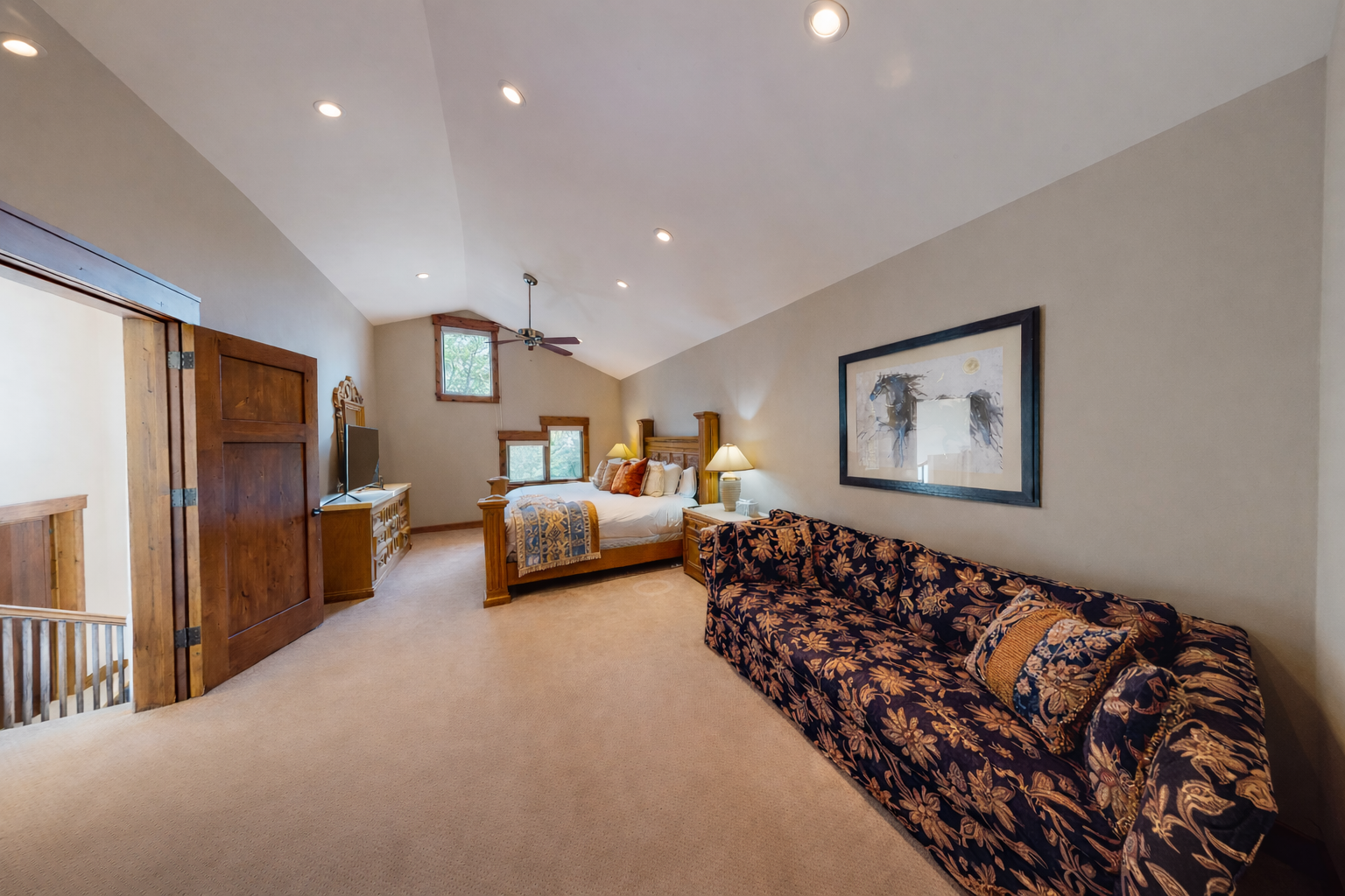 Unwind in your peaceful bedroom sanctuary with rich wood furnishings, cathedral ceilings, and soft lighting creating pure tranquility.