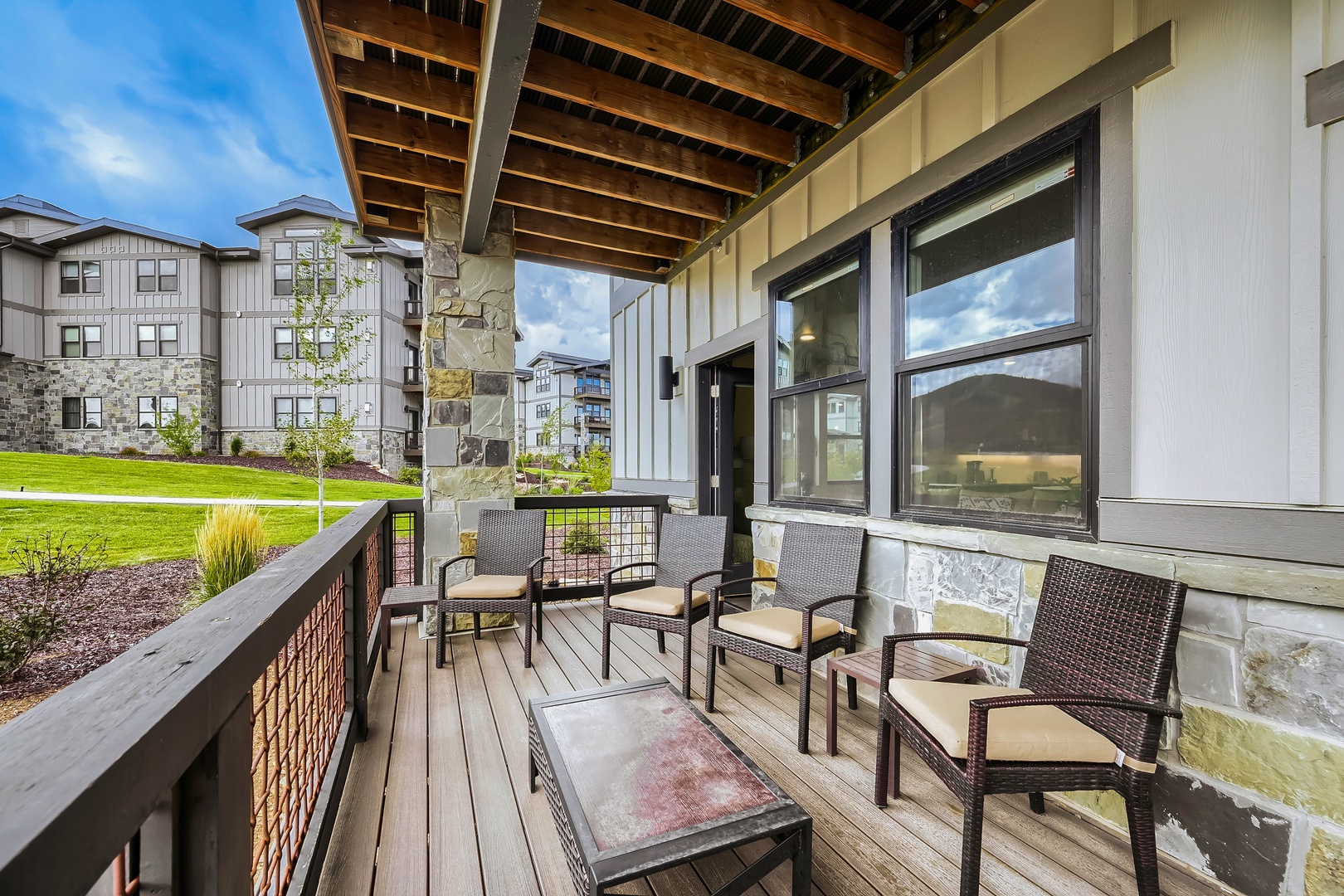 Step onto your private covered patio and breathe in the fresh air while relaxing in cushioned seating. With open views of the surrounding grounds, this is your personal outdoor retreat for morning coffee or evening unwinding.