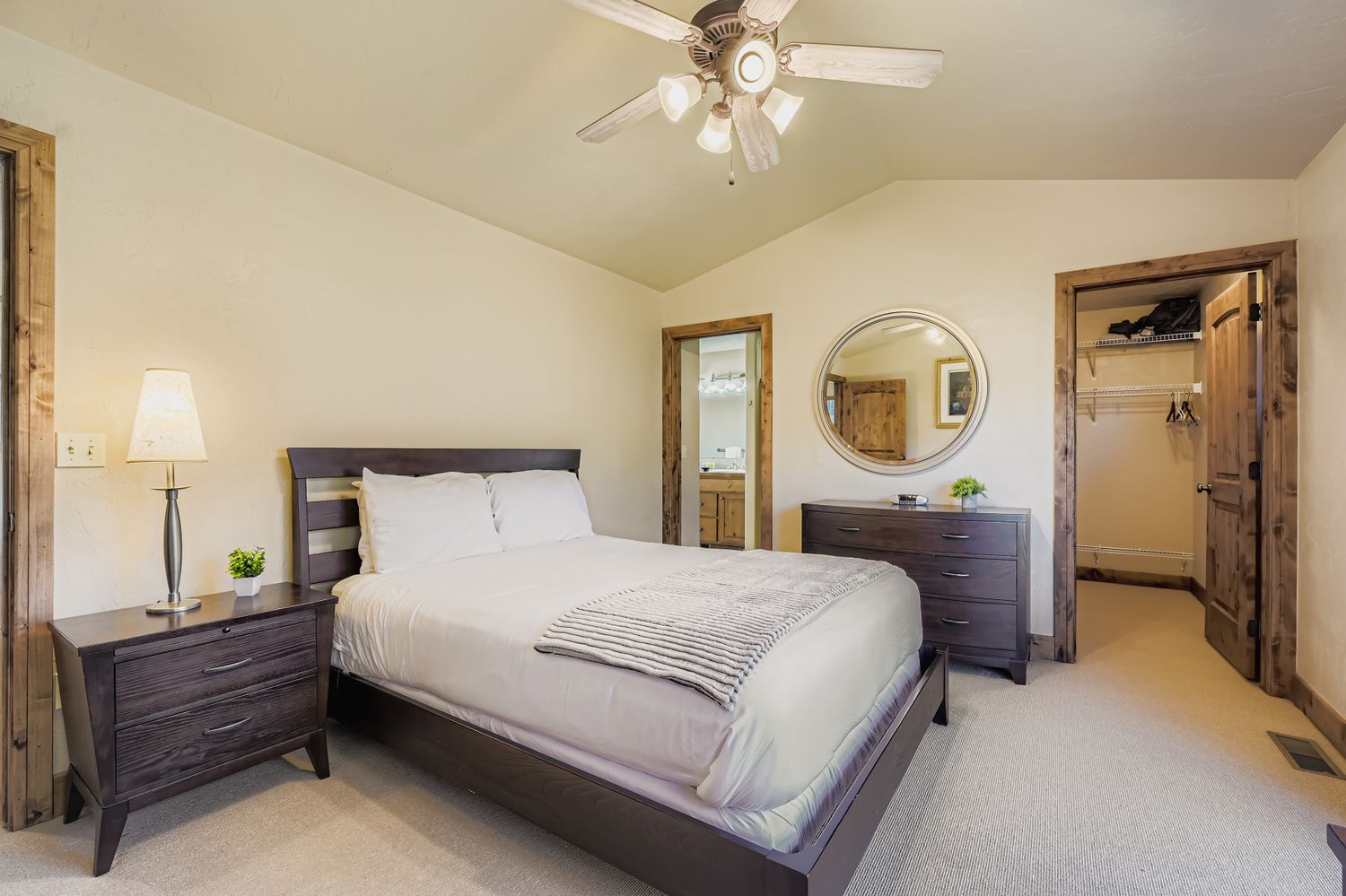 Relax in your comfortable bedroom featuring a plush bed, modern furnishings, and convenient ceiling fan to keep you cool during your stay.