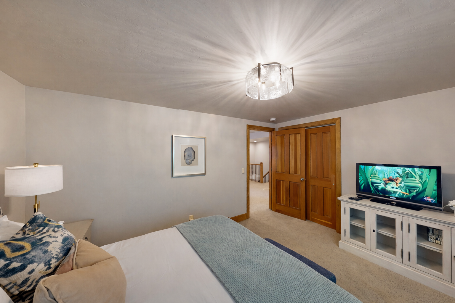 Drift off to peaceful sleep in your cozy queen bedroom, surrounded by warm wood trim and gentle natural light filtering through treetop views.