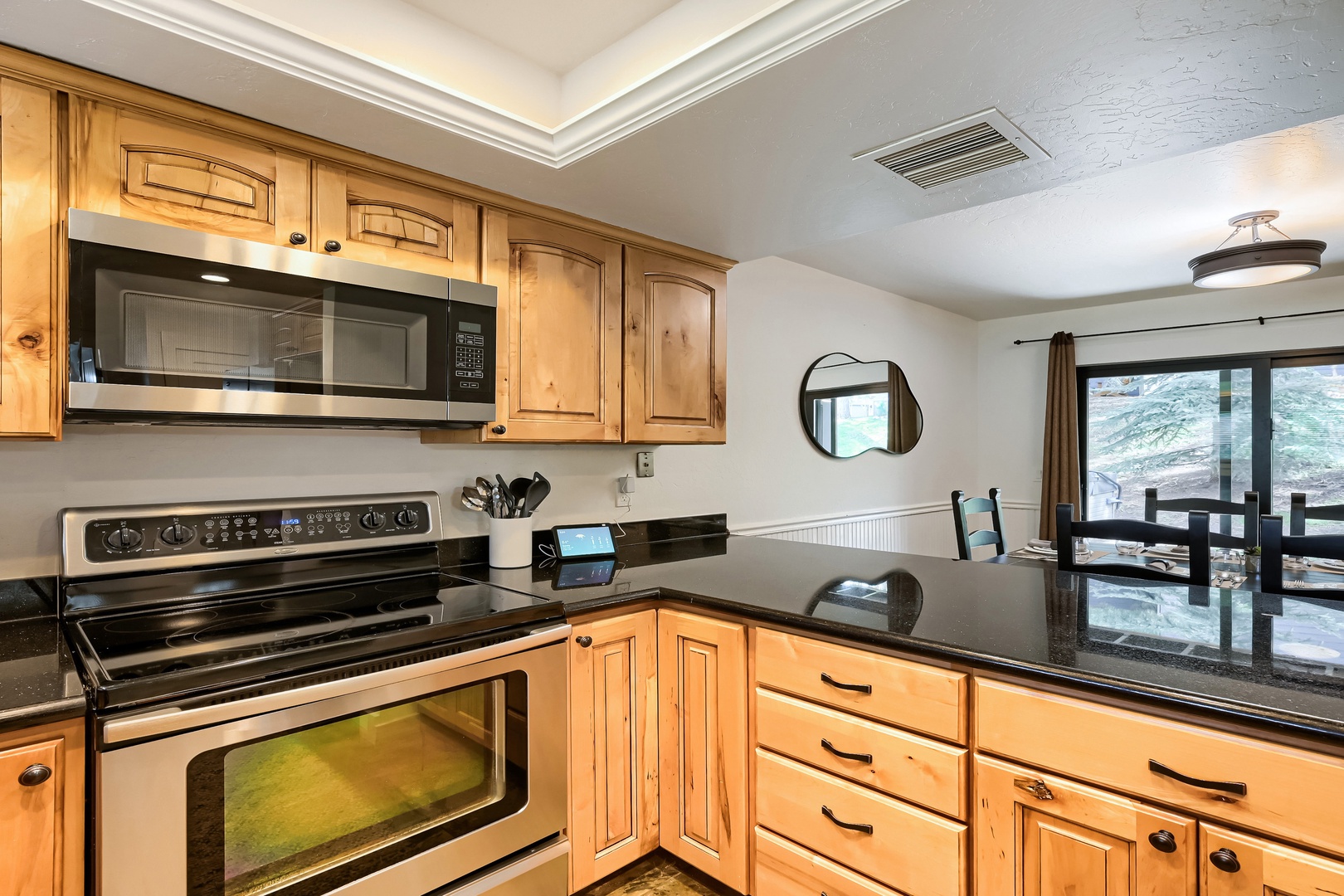 Your fully-equipped kitchen features warm wood cabinetry and sleek granite counters, with everything you need to prepare meals during your mountain getaway.