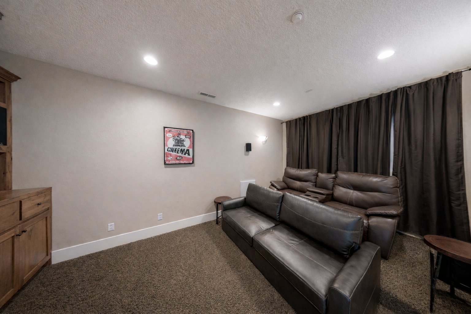 Sink into plush leather recliners and enjoy movie nights on your large flat-screen TV in this cozy entertainment space.