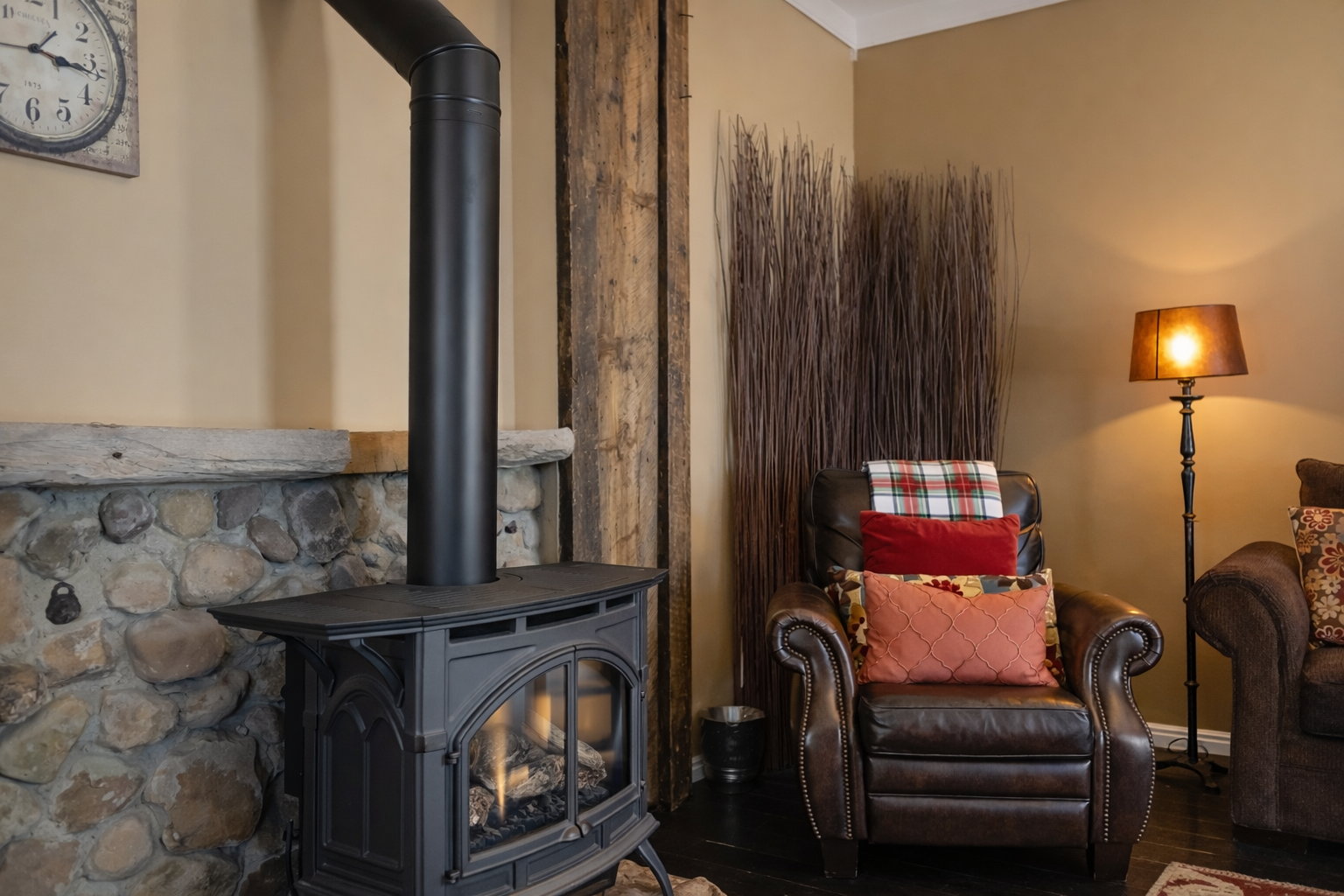 Cozy up in your leather armchair beside the crackling fireplace, where warm flames and soft lamplight create the perfect evening retreat.