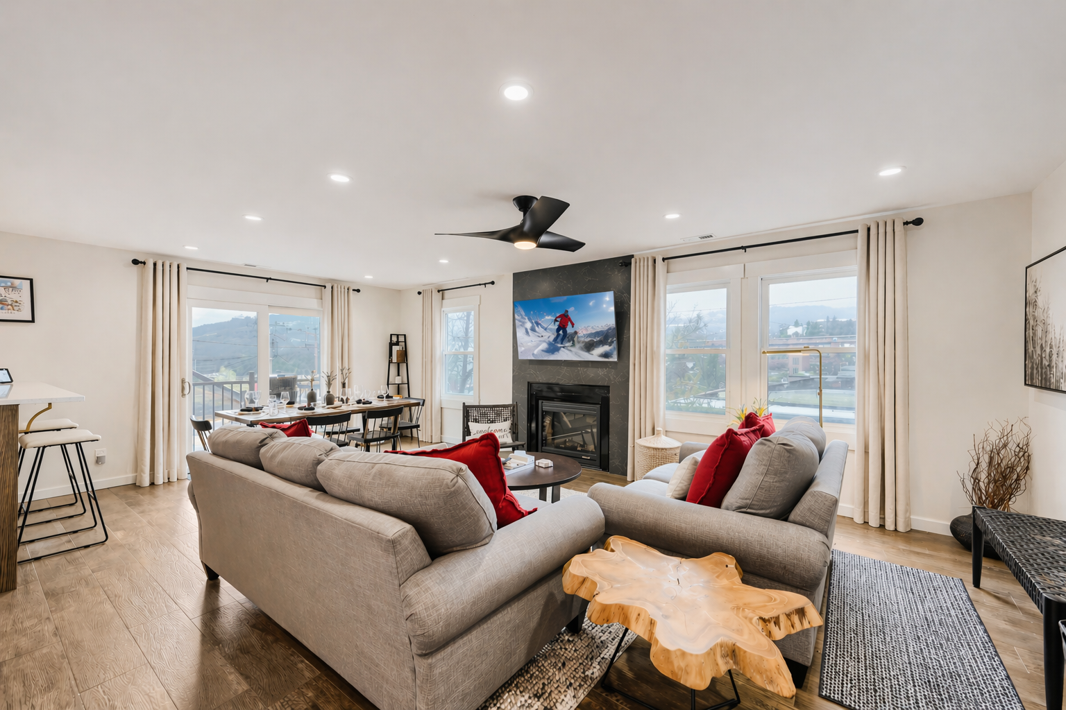 Unwind in your spacious living room with mountain views, cozy fireplace, and modern comforts for the perfect alpine retreat.