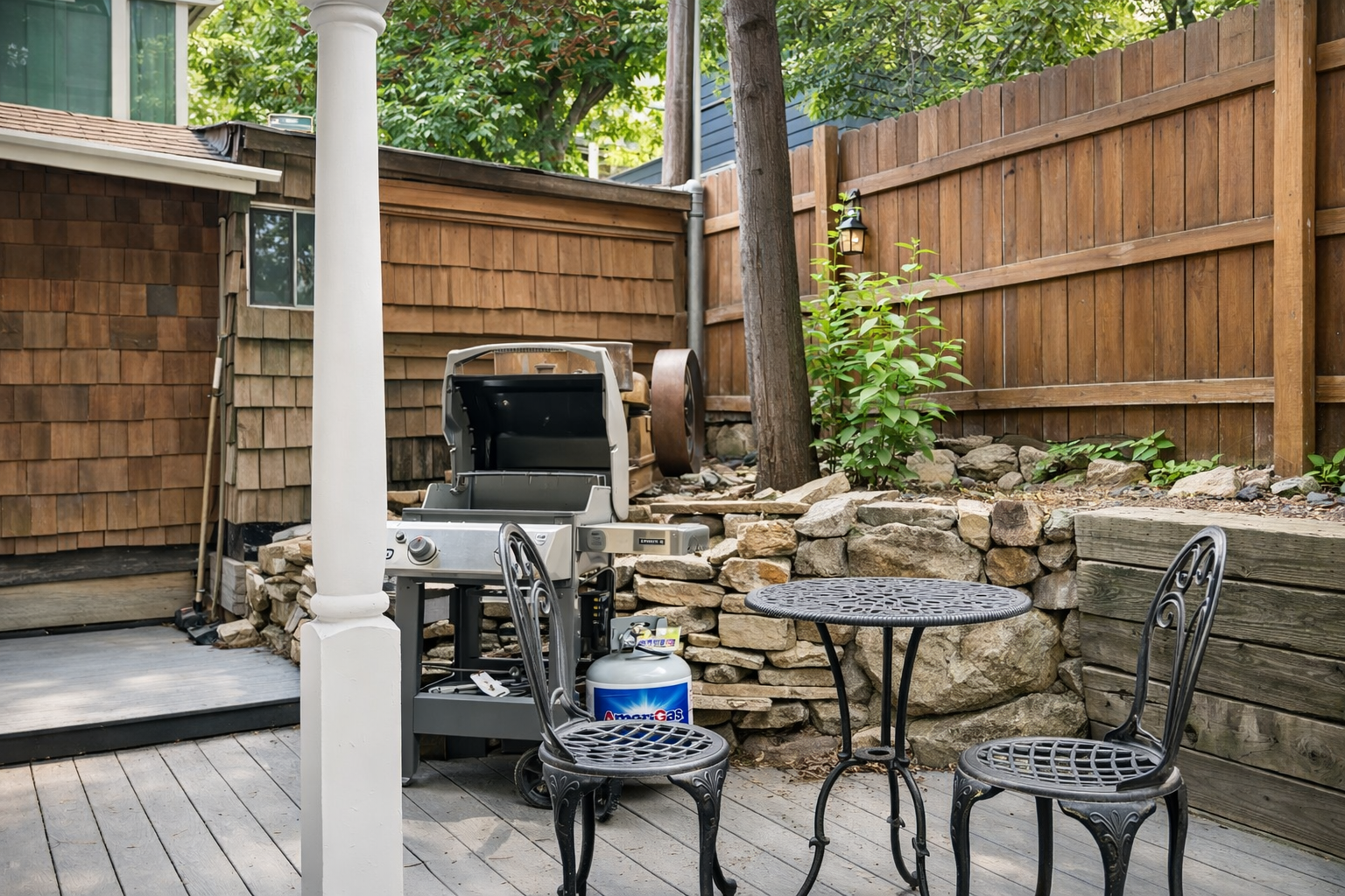 Fire up the grill for your perfect outdoor feast in this charming backyard retreat, complete with rustic charm and natural stone accents.