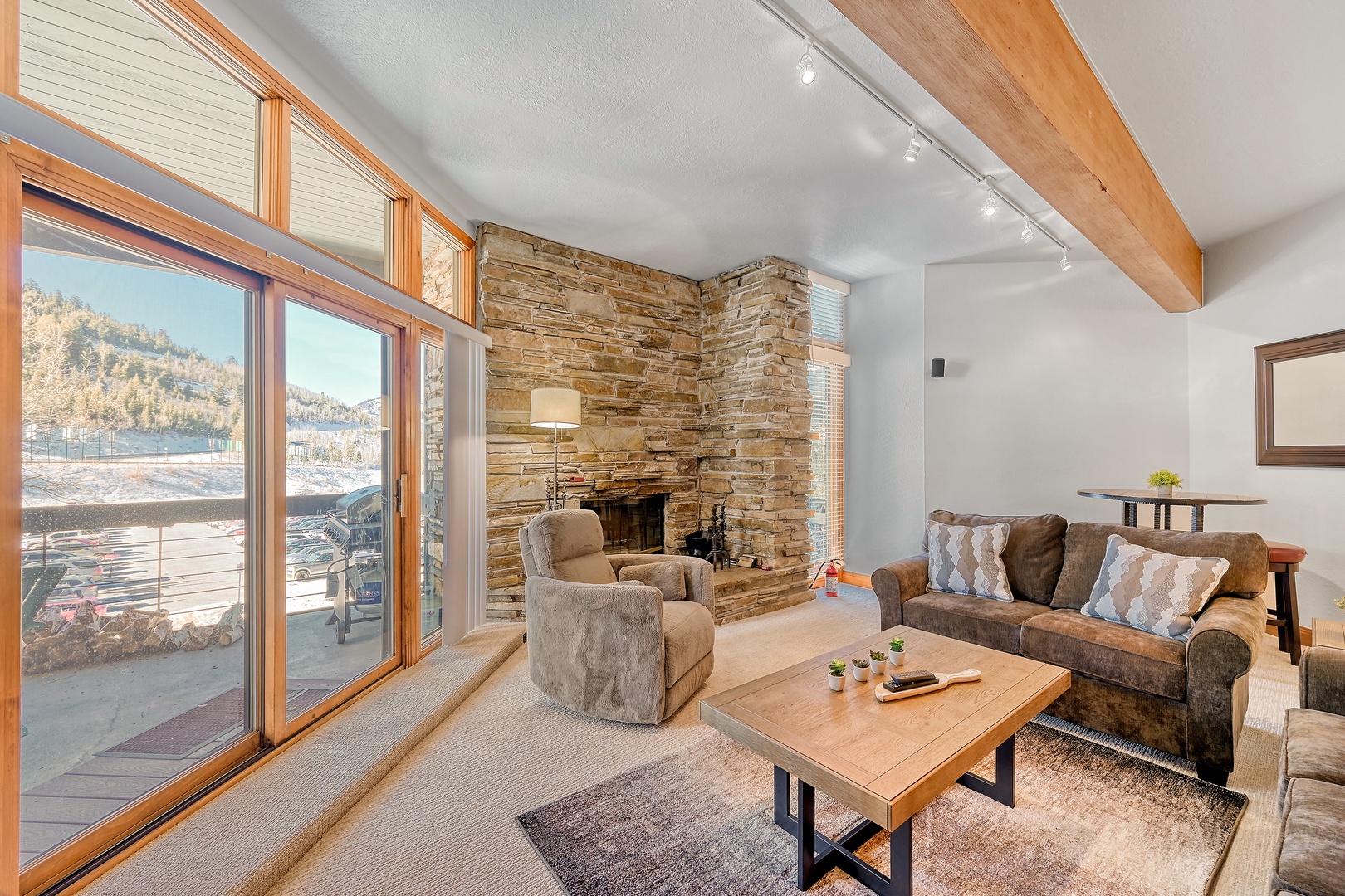 Cozy up in your mountain retreat with a stunning stone fireplace, panoramic views, and rustic-modern charm for unforgettable relaxation.
