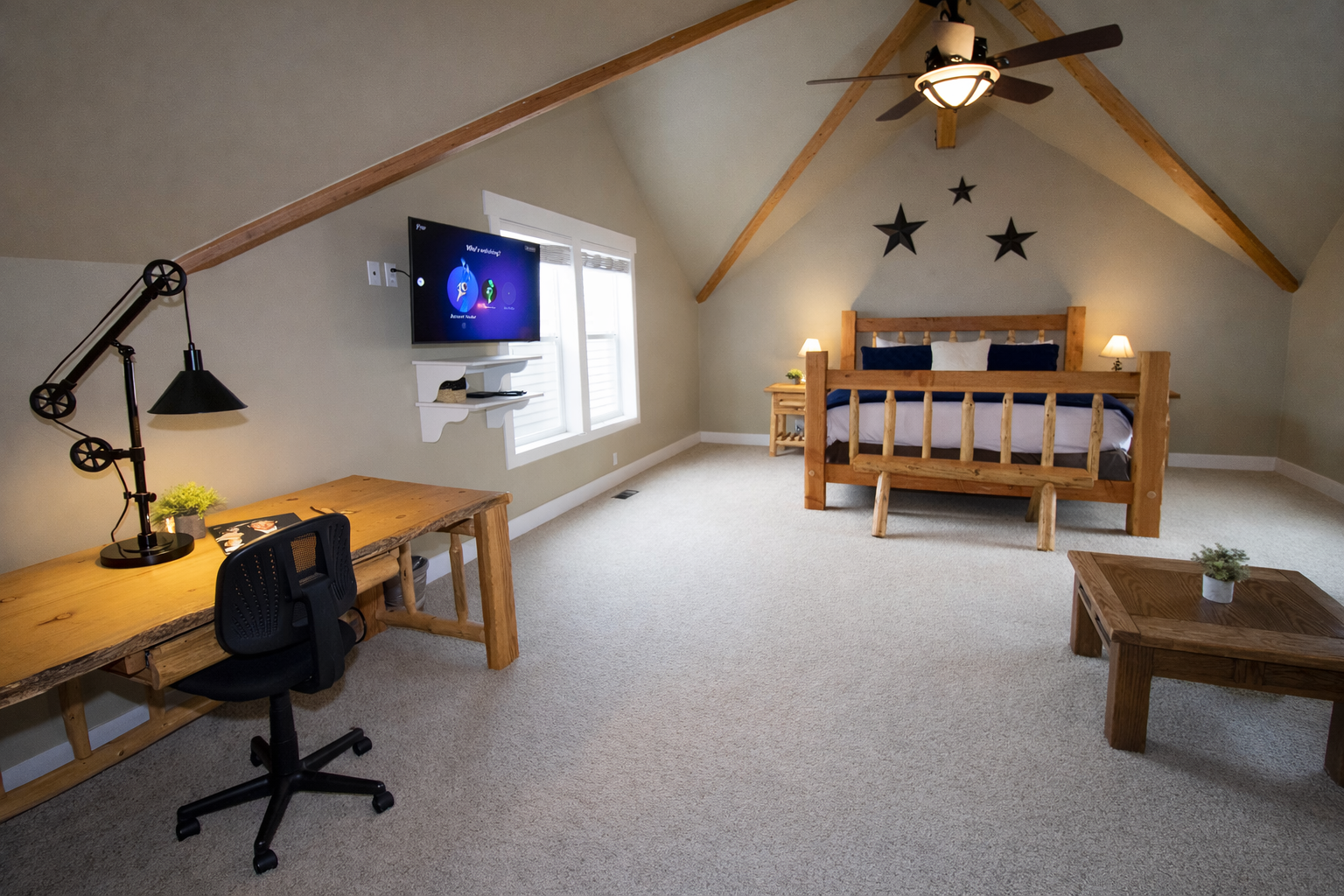 Relax in this spacious master suite on its own private floor. Features include a king-sized log bed, vaulted ceilings, and a large walk-in closet for the ultimate mountain retreat.