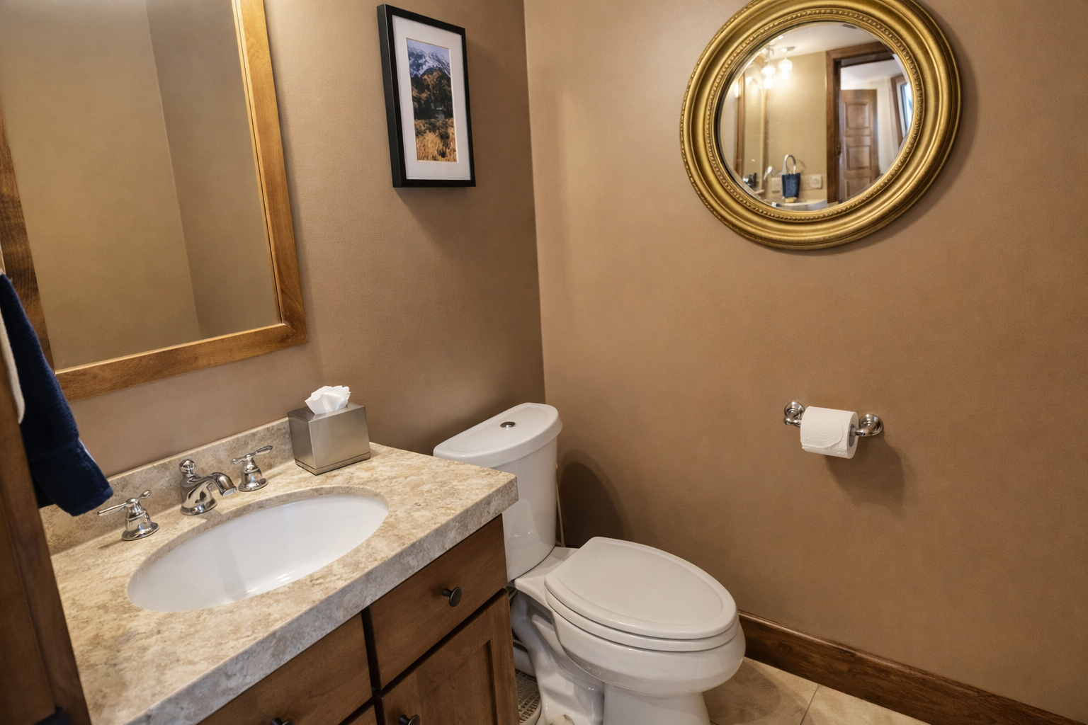 Your elegant powder room features marble countertops, warm lighting, and thoughtful amenities for your comfort.