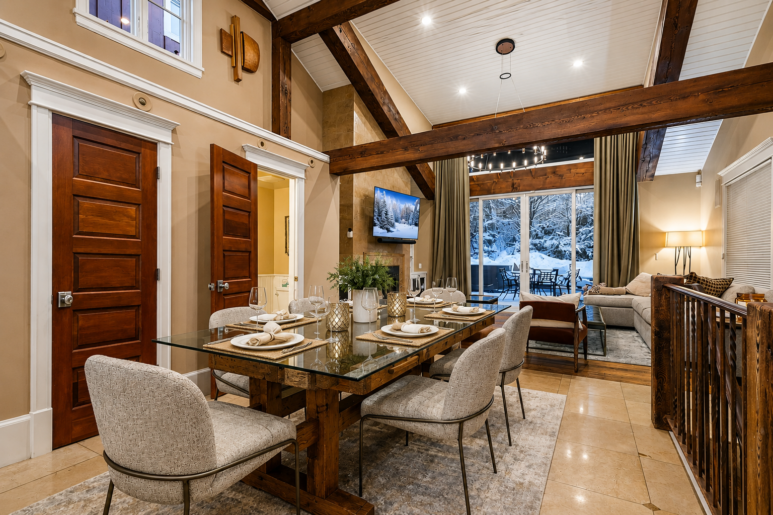 Step into your cozy mountain retreat with vaulted ceilings, warm wood beams, and inviting dining and living spaces that open to snowy views—a perfect setting for gathering with loved ones.