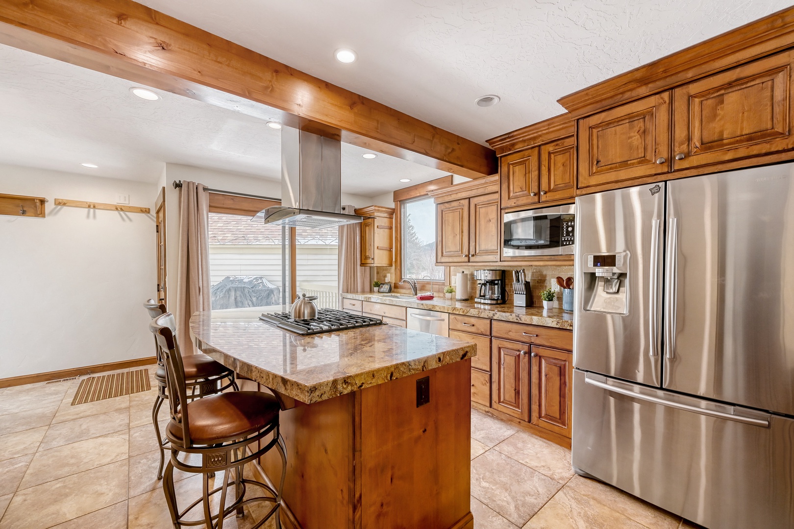 Your spacious kitchen features granite countertops, stainless steel appliances, and rustic wood beams for memorable meal preparation.