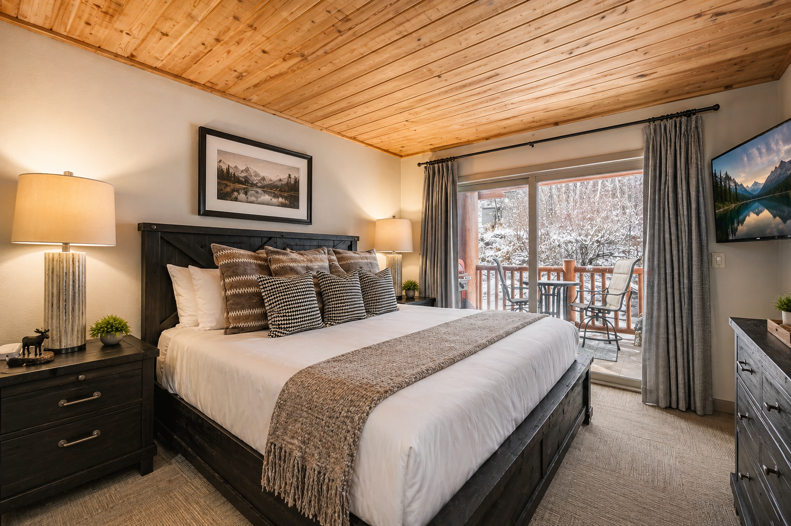 Sink into the plush king bed under warm wooden beams, wake to snowy mountain views from your private balcony, and enjoy cozy evenings in this inviting retreat.