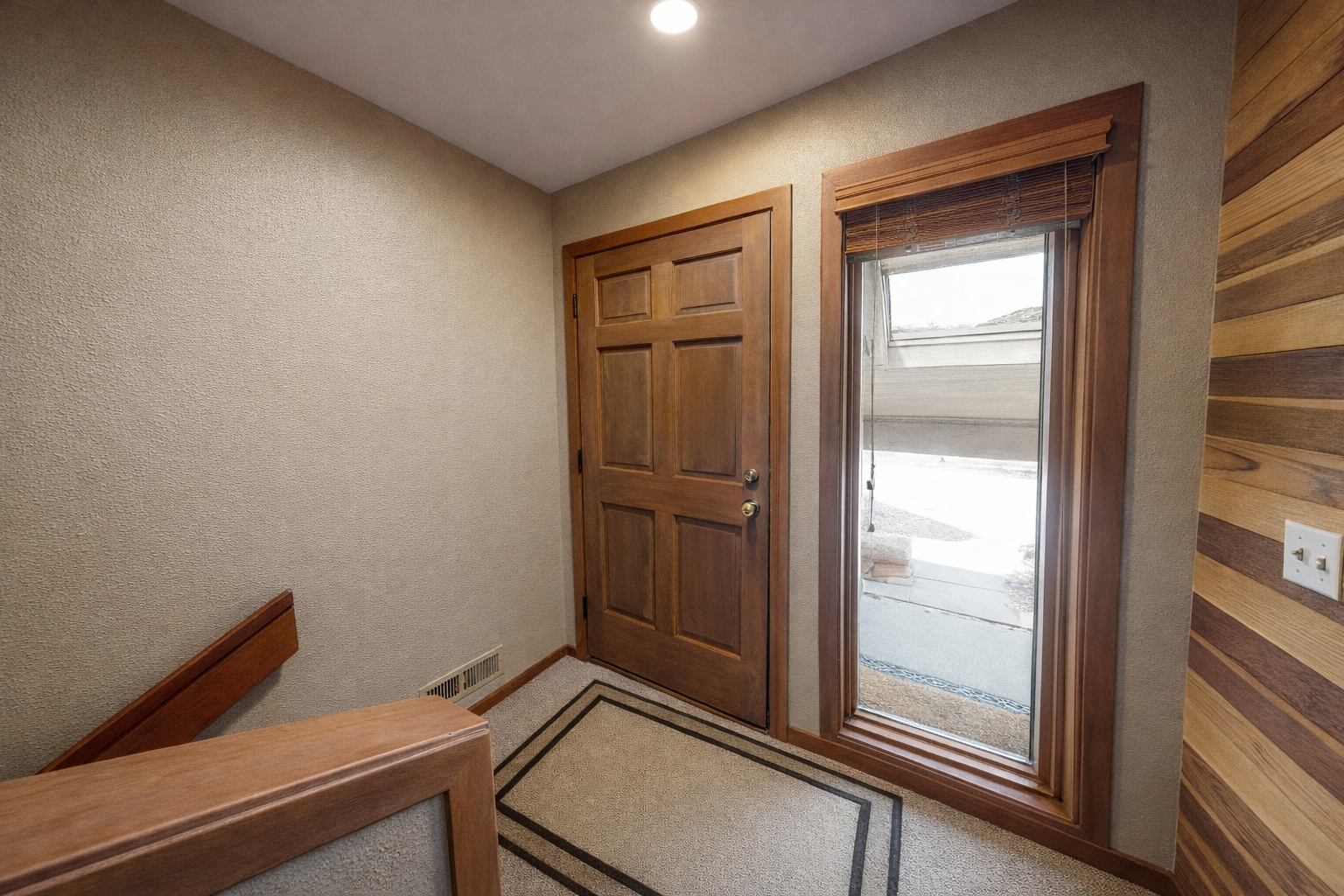 Step into your welcoming entry hall with warm wood accents and natural light streaming through the window.