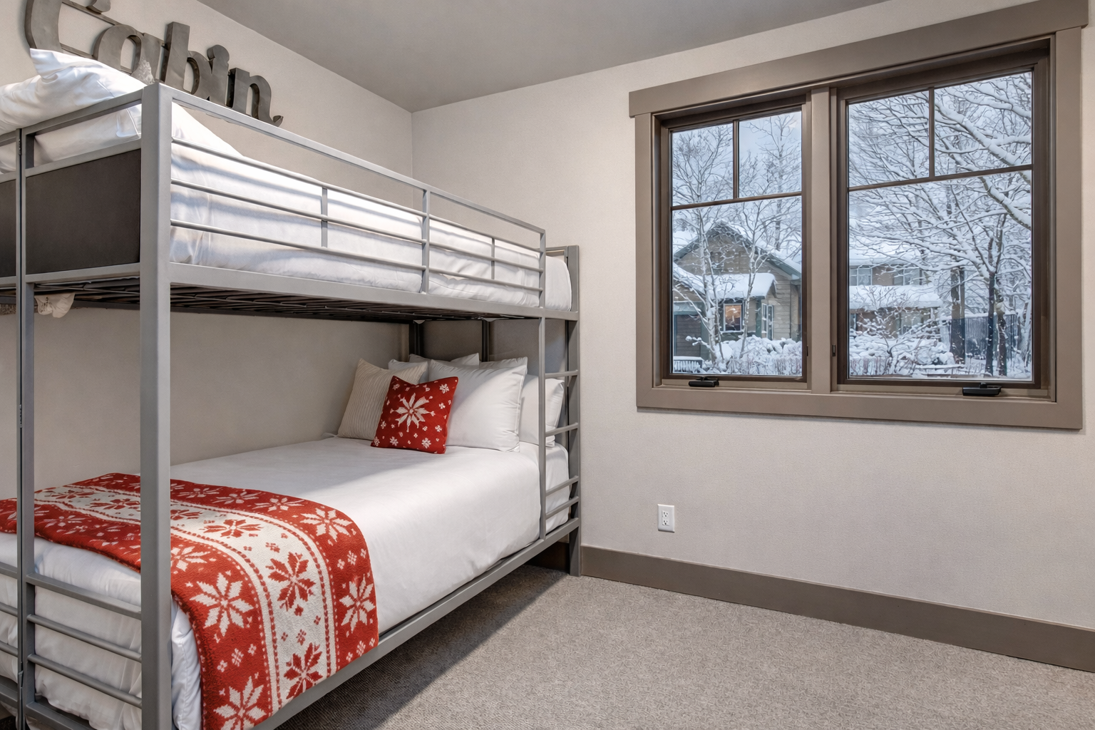 Your cozy bunk beds feature festive red linens, while your window frames a winter wonderland outside.