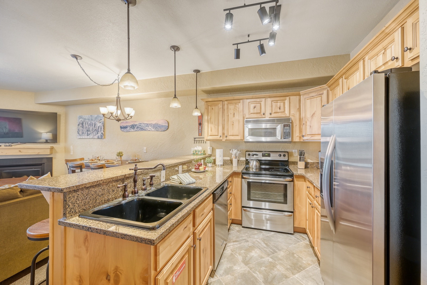 Your spacious kitchen features granite counters, stainless appliances, and warm wood cabinetry perfect for preparing memorable meals together.