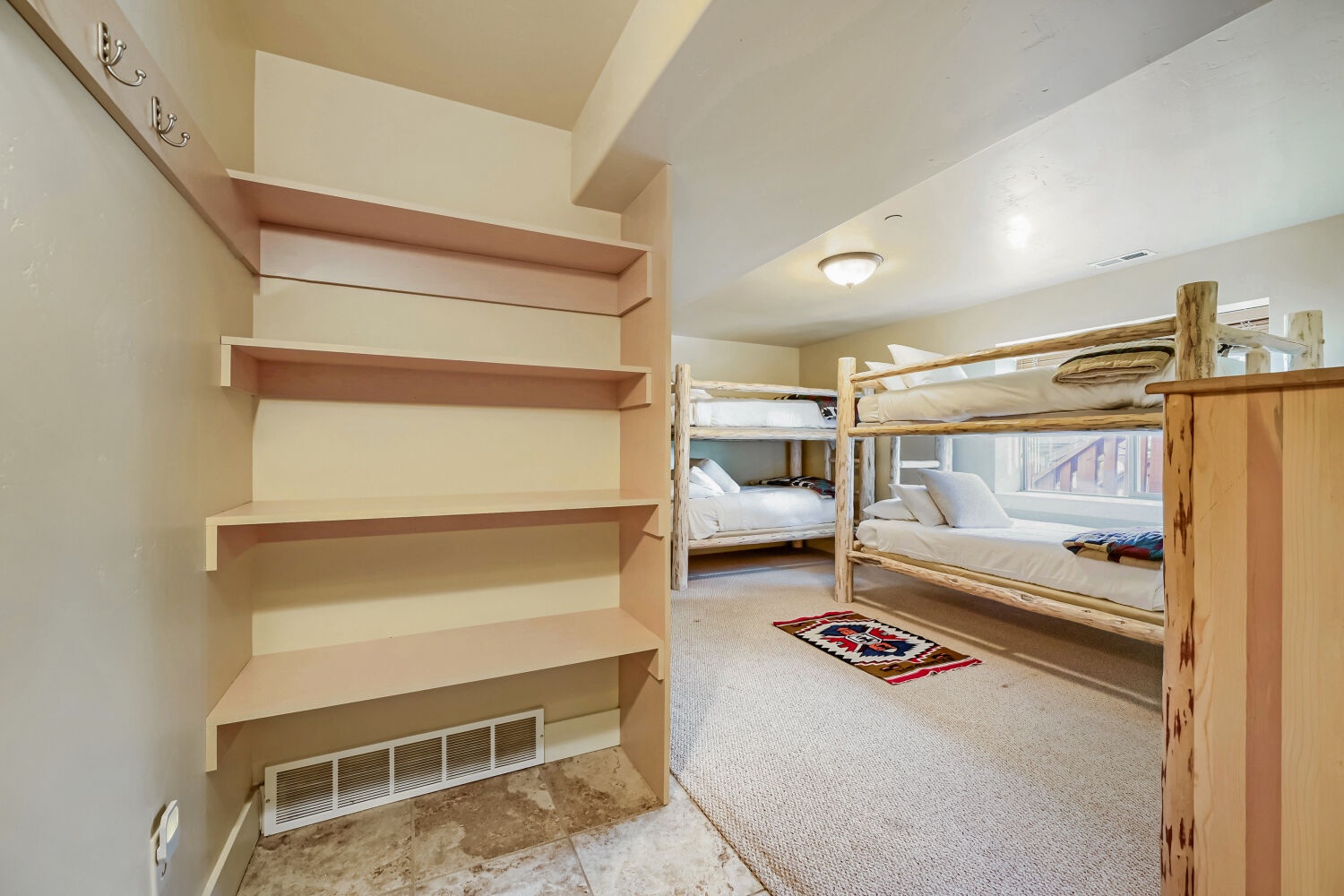 Your group will love this cozy bunk room, designed with rustic wood bunks and plenty of space for everyone to rest after a day of adventure.