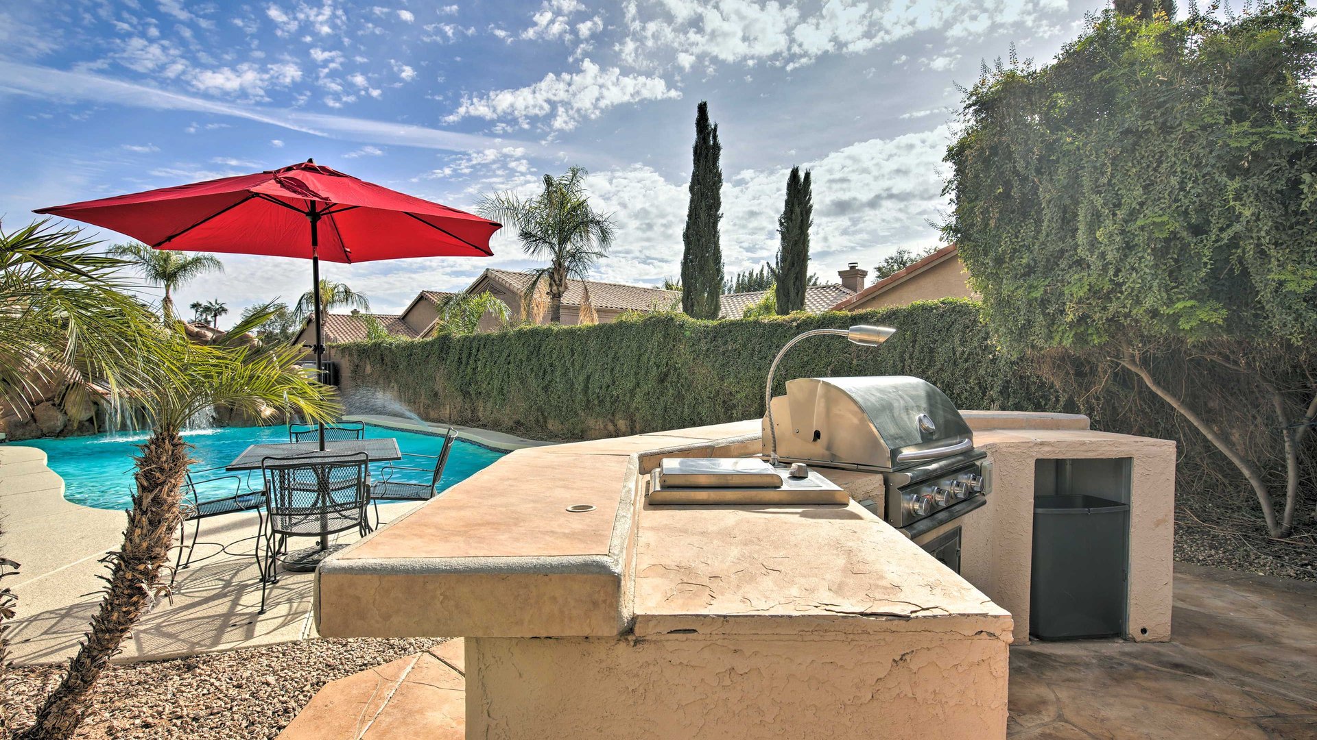 Your private outdoor BBQ awaits poolside dining under desert skies, with a built-in grill ready for memorable meals