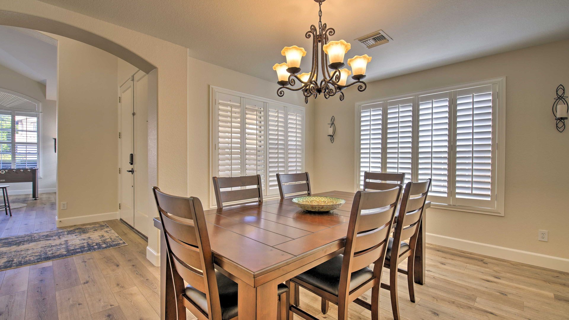 Your elegant dining room features warm wood tones