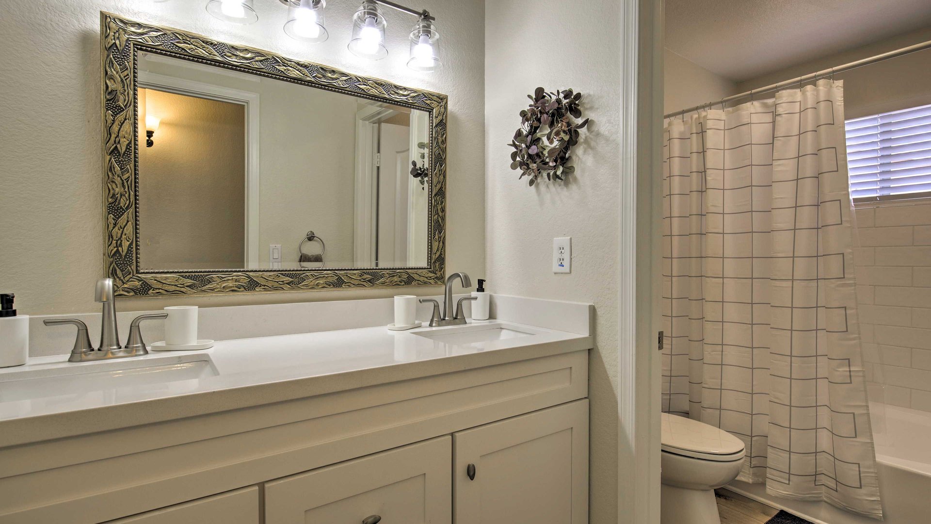 Refresh in your elegant bathroom featuring dual vanities