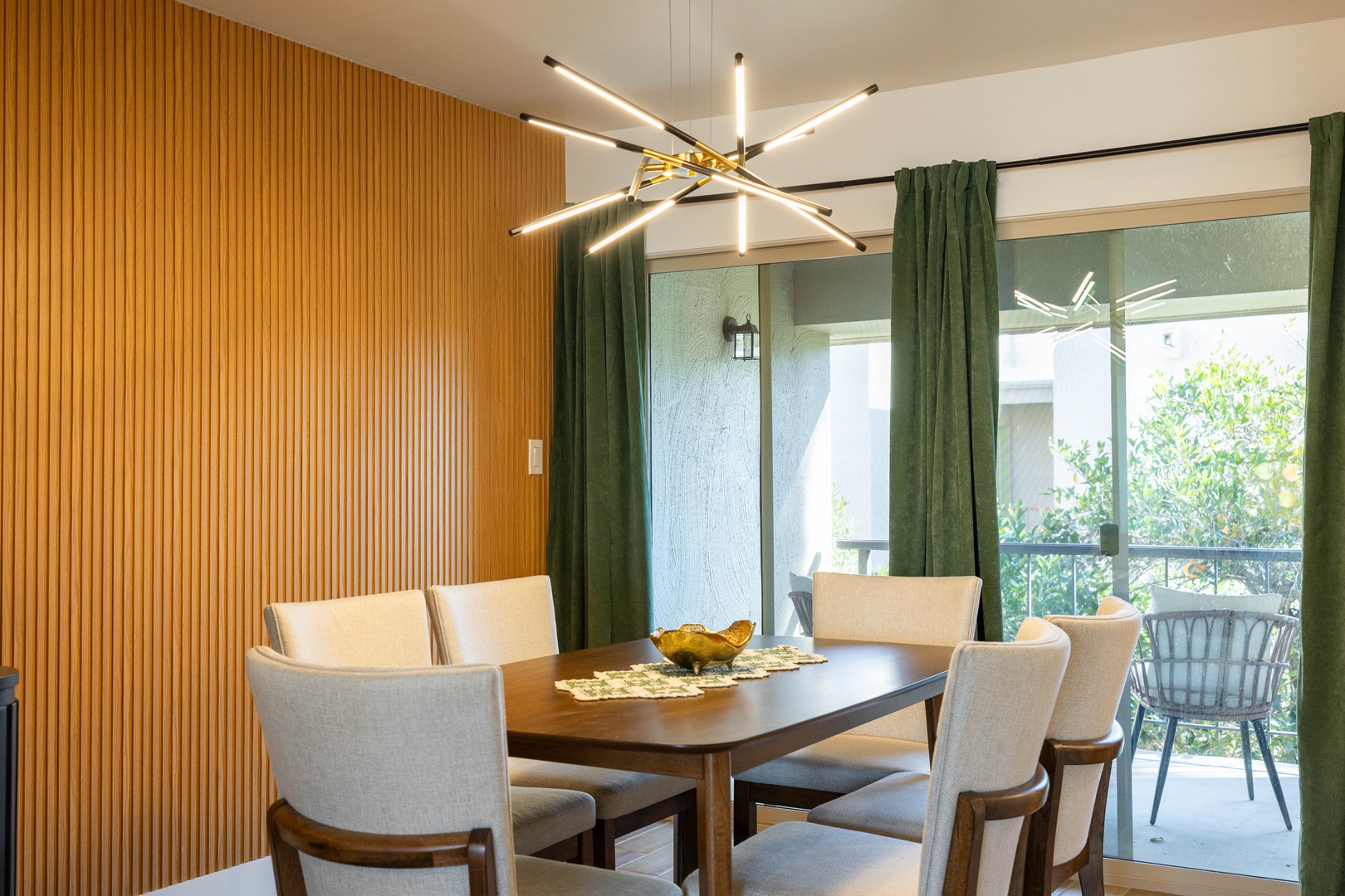Dining area features warm wood paneling and modern lighting.