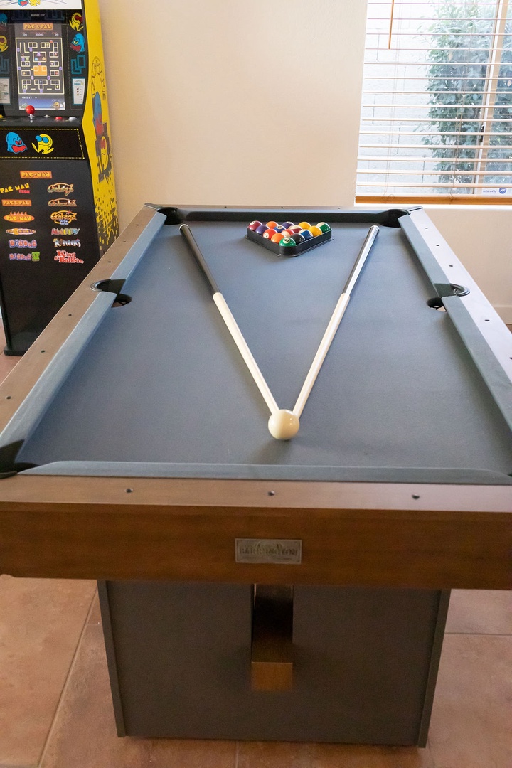 Challenge friends to a game of pool in your private entertainment space, complete with arcade games for endless fun.