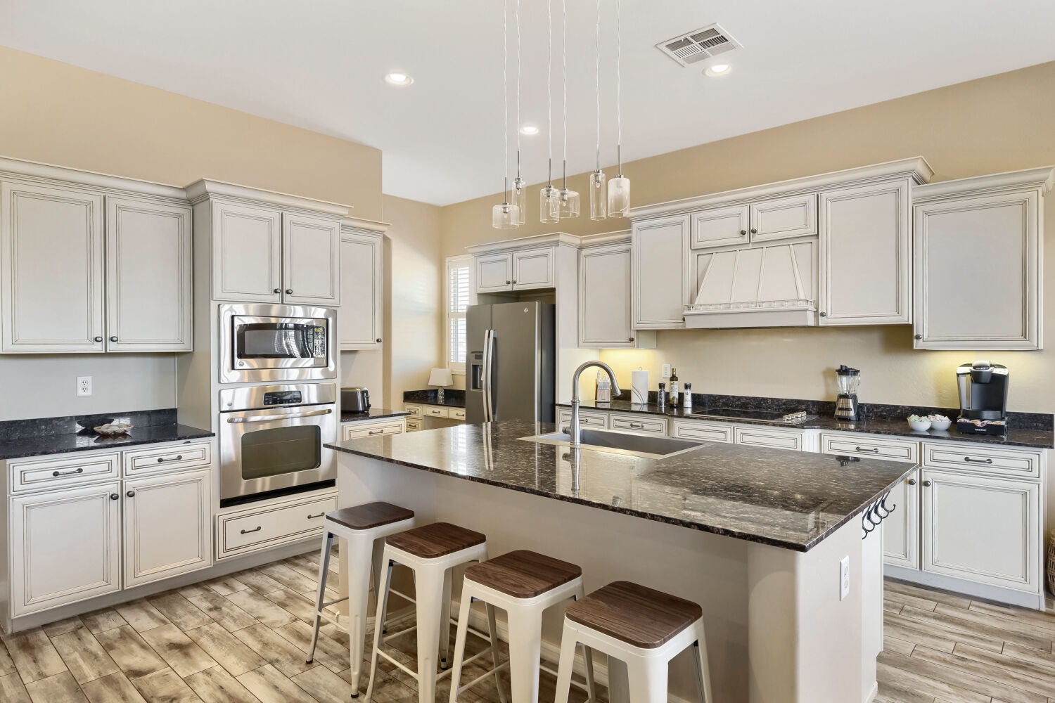 Step into your chef's dream: a stunning kitchen with granite countertops, sleek stainless appliances, and a spacious island where you can prep meals or gather with loved ones over morning coffee.